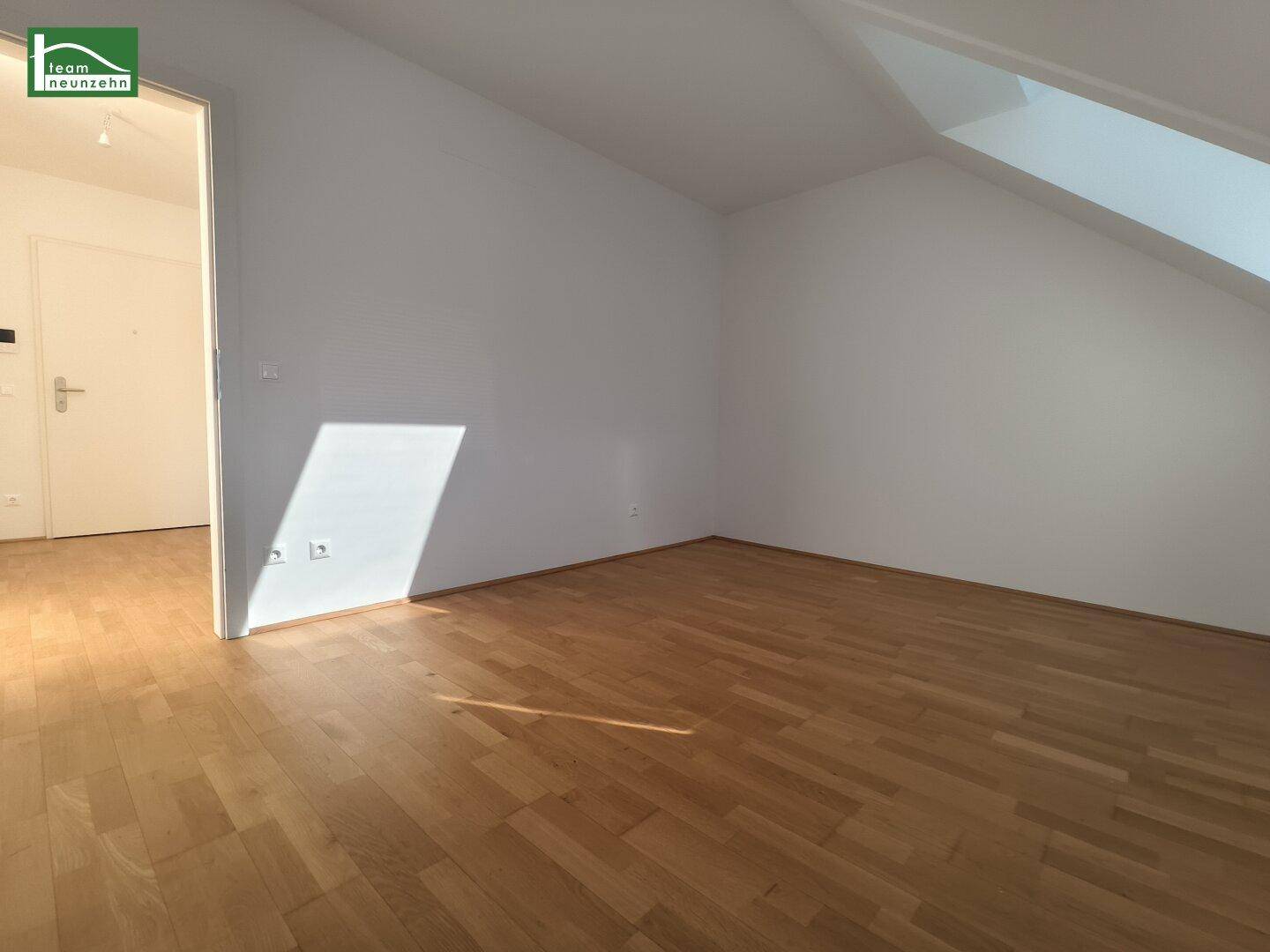 Geräumiges Zimmer im Dachgeschoss mit Parkettboden und viel Tageslicht, ideal als Schlaf- oder Arbeitszimmer.