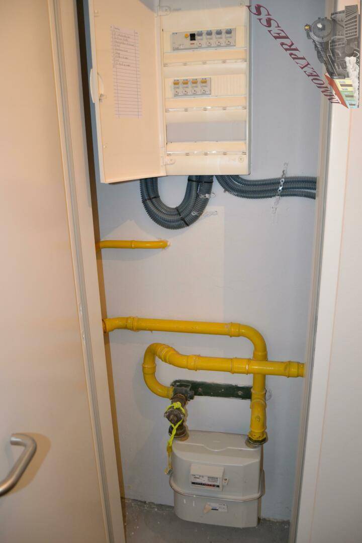 Technikraum mit Gaszähler, gelben Gasleitungen und elektrischem Sicherungskasten, gut zugänglich.
