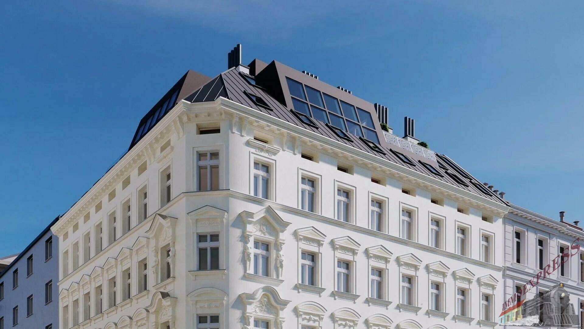 Historische Fassade eines Gebäudes mit modernem Dachausbau und vielen Dachfenstern.