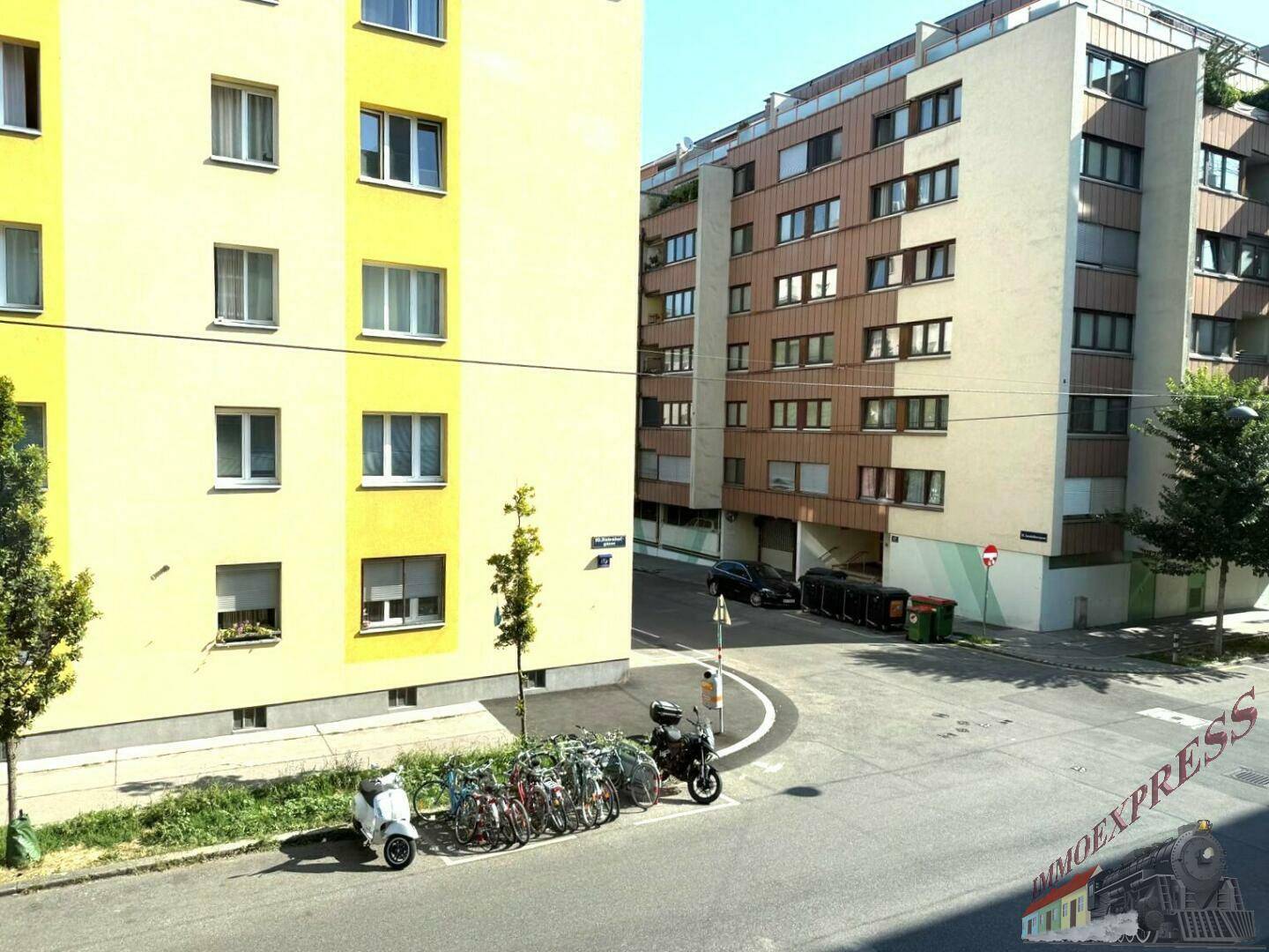 Blick auf die umliegenden Wohngebäude und die Straße mit Fahrradabstellplätzen.