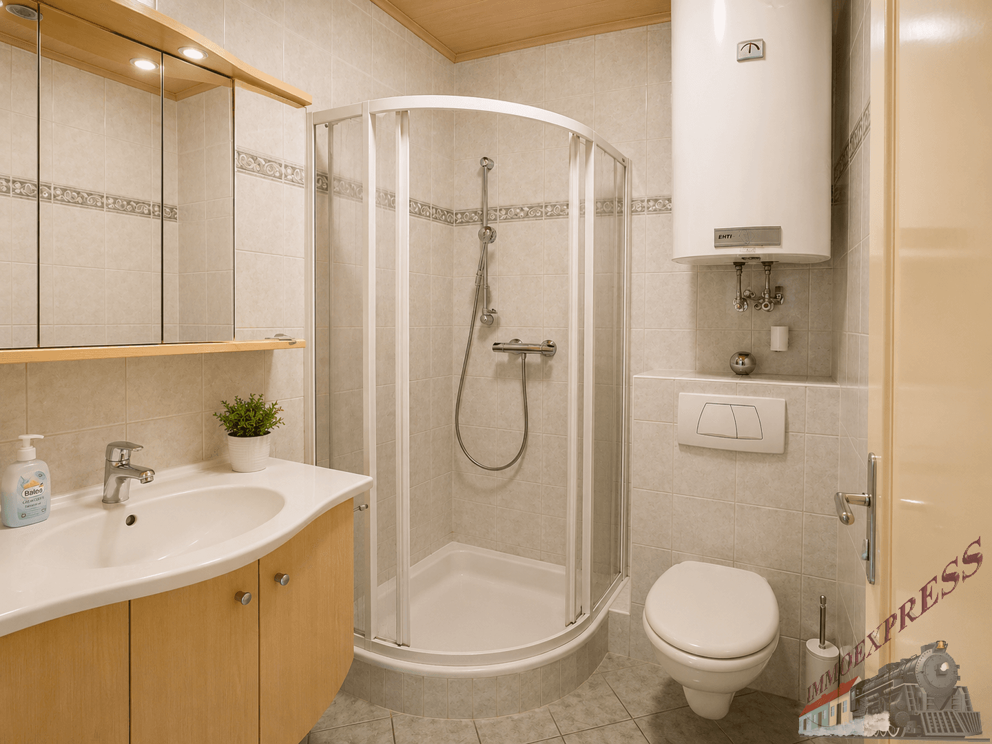 Funktionales Badezimmer mit Duschkabine, WC, Waschbecken und hellen Fliesen.