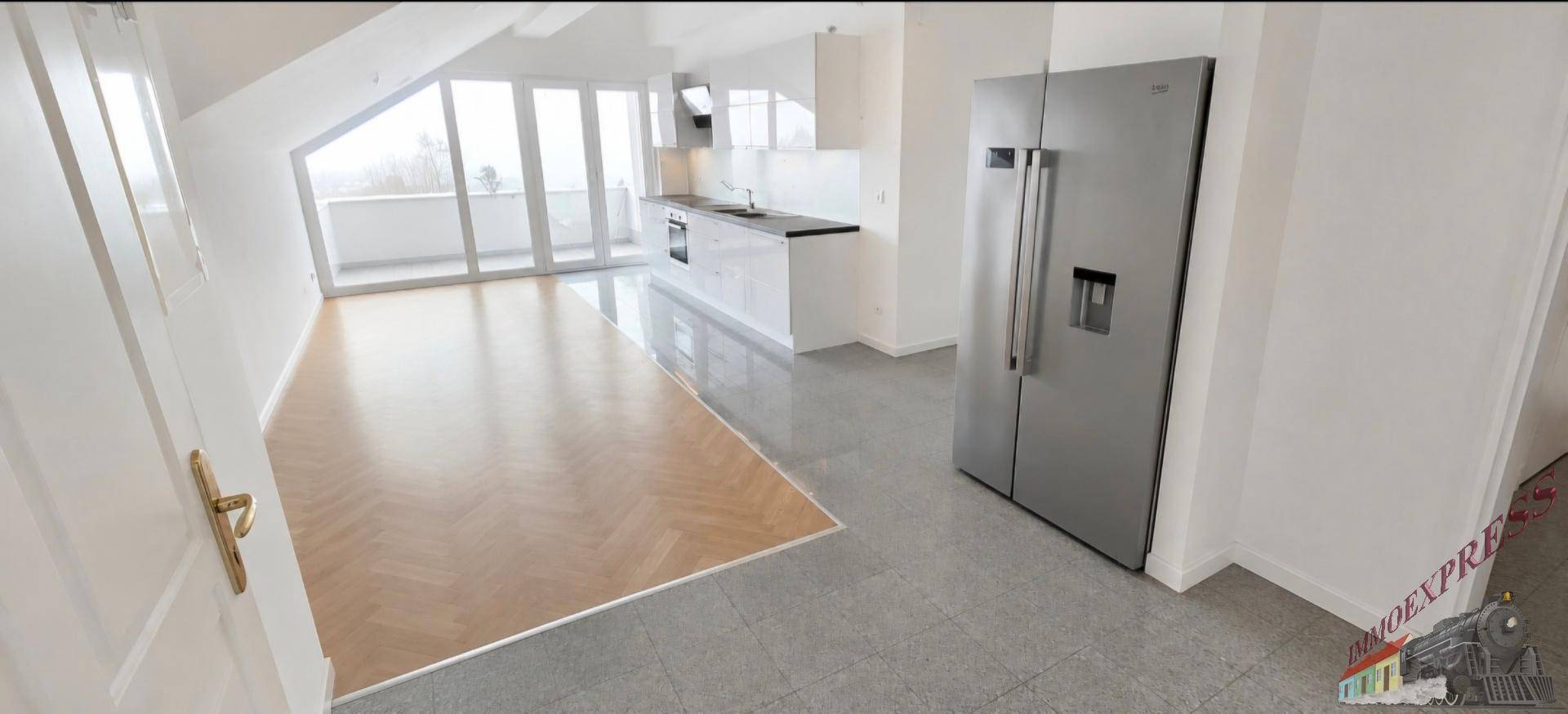 Heller offener Wohn-Essbereich mit moderner Küche, Parkettboden und Zugang zum Balkon.