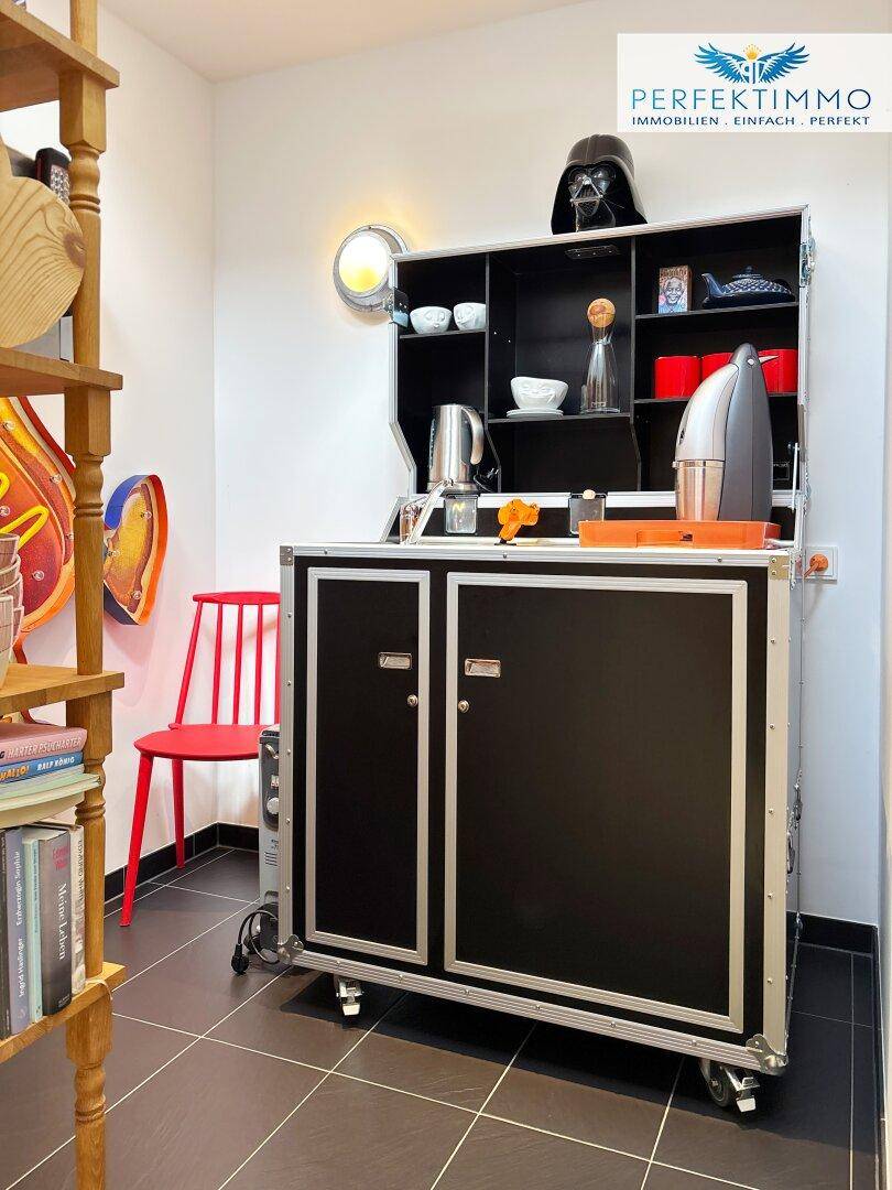 Funktionale Küchenzeile auf Rollen mit schwarzem Design und offenem Regal für Utensilien.
