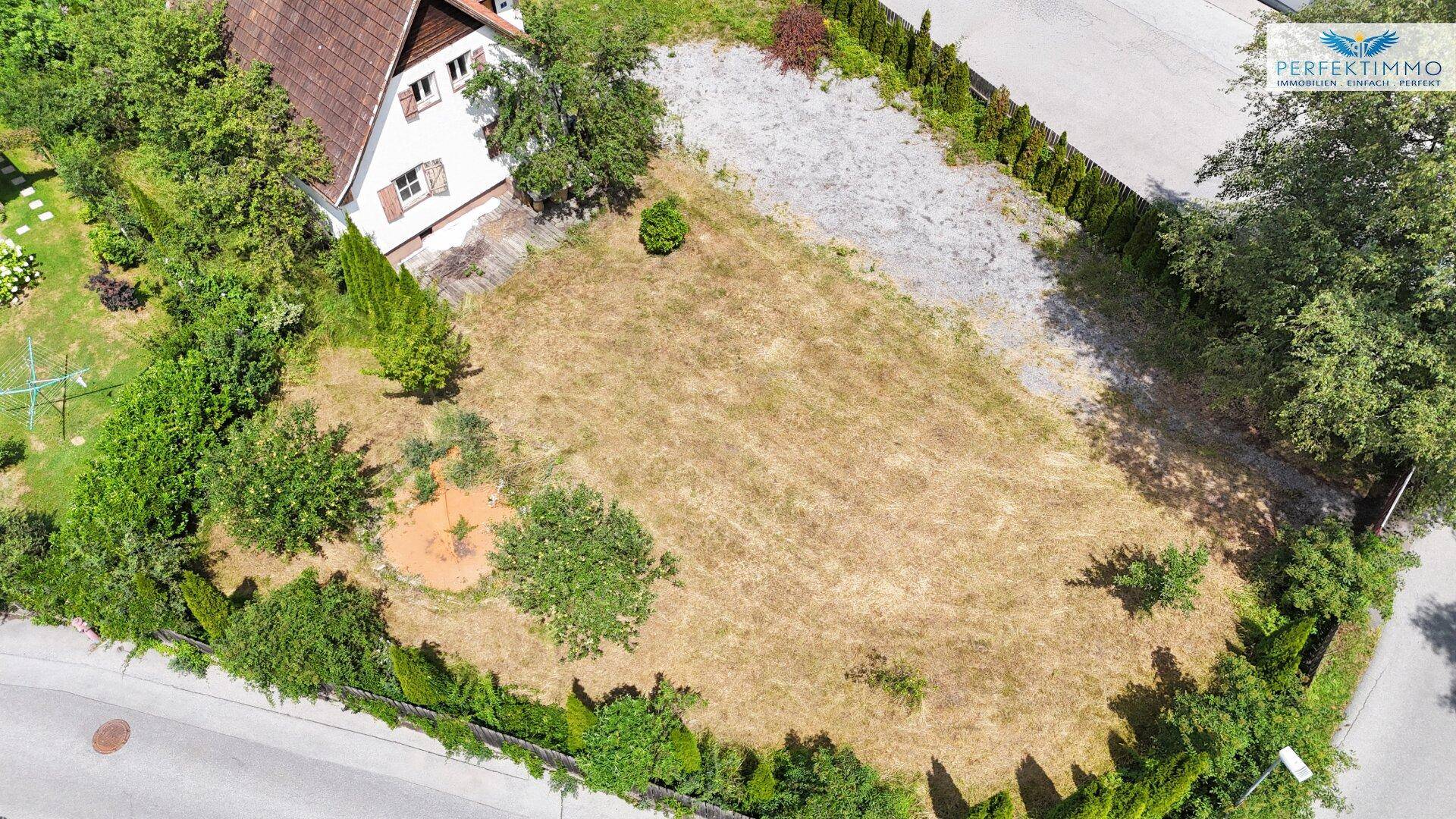 Luftbild eines Wohnhauses mit großem Grundstück, umgeben von Bäumen und Hecken.