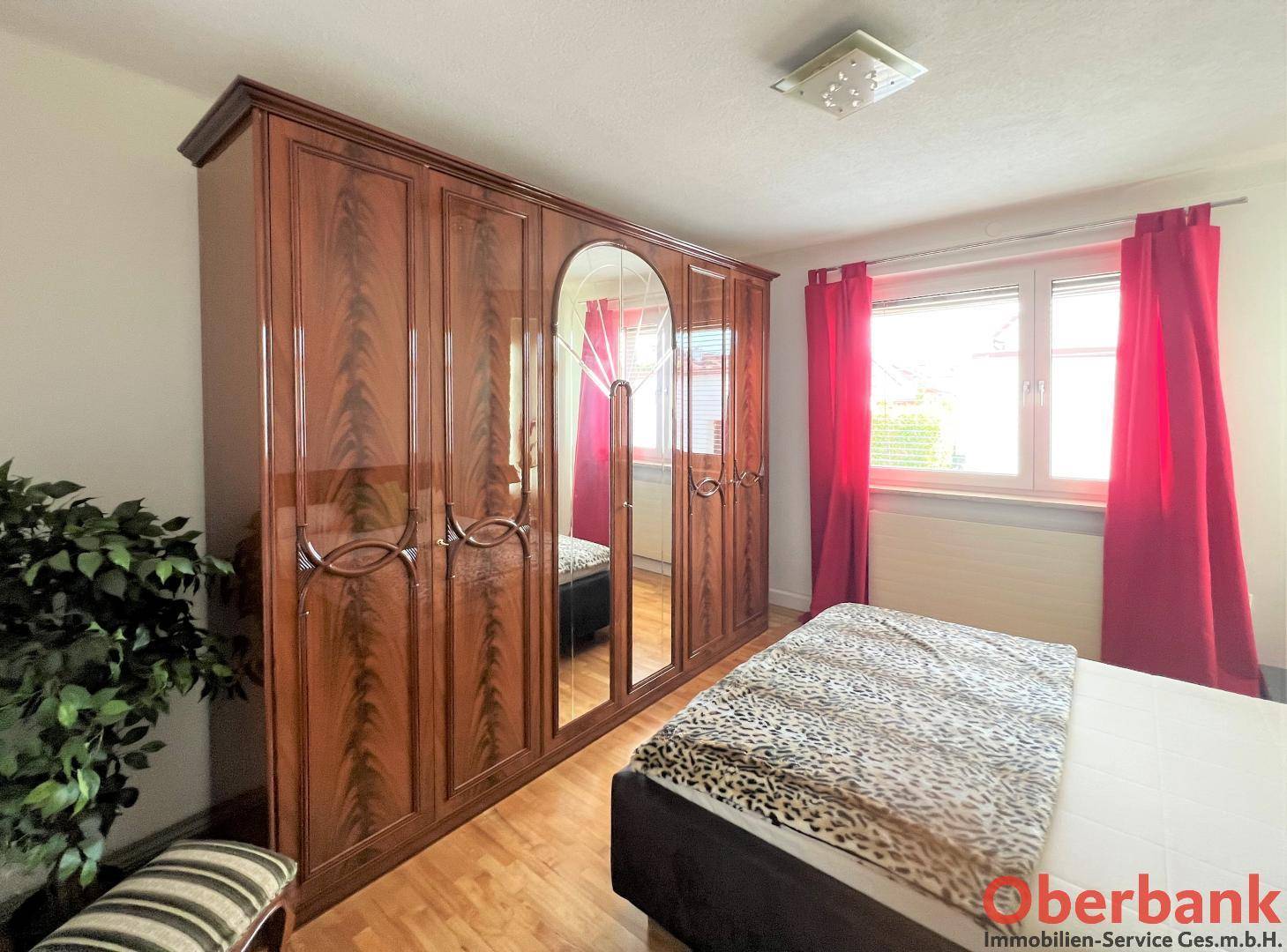 Großer, eleganter Holzschrank mit Spiegeltüren im Schlafzimmer.