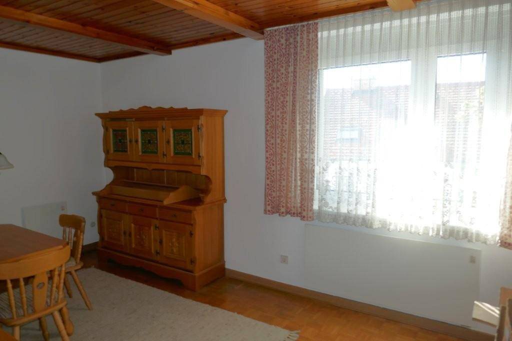 Gemütlicher Essbereich mit Holzbalkendecke, traditionellen Möbeln und viel Tageslicht.