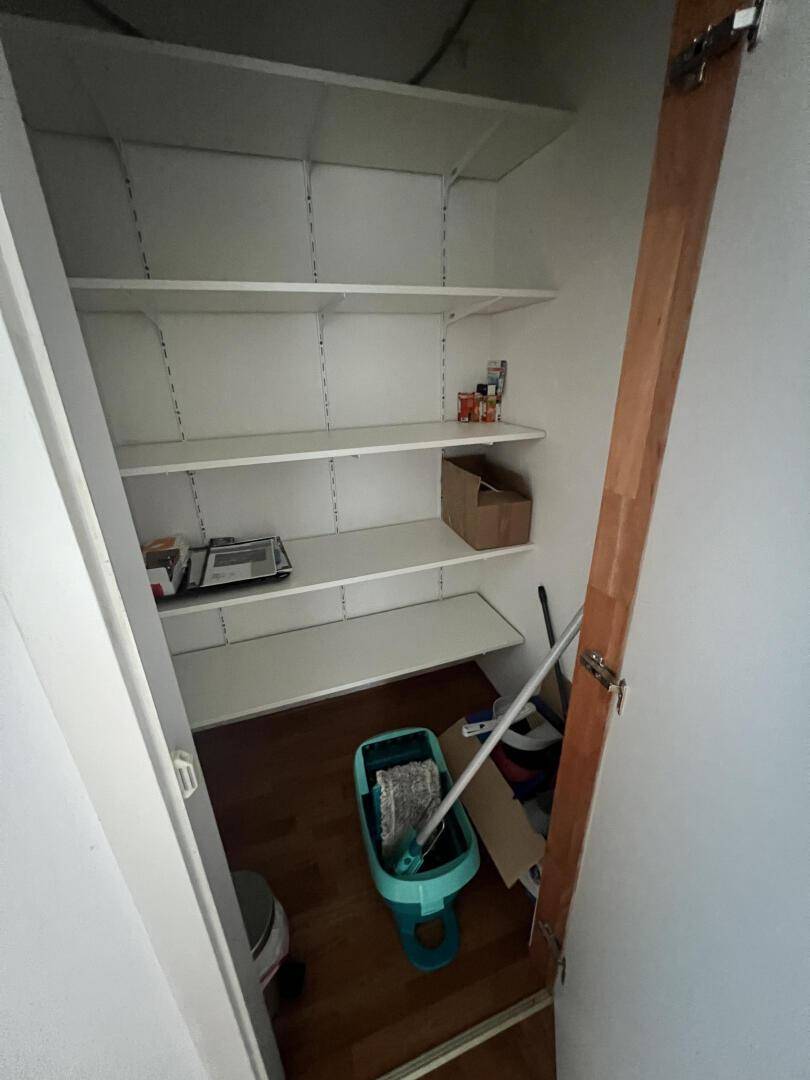 Praktischer Abstellraum mit Regalen für Lagerung und Haushaltsutensilien.