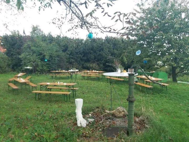 Großer Gartenbereich mit mehreren Biertischgarnituren, ideal für Veranstaltungen im Freien und geselliges Beisammensein.