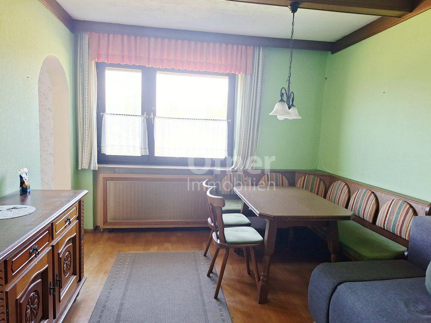 Gemütlicher Essbereich mit Holztisch, Eckbank und traditioneller Einrichtung.