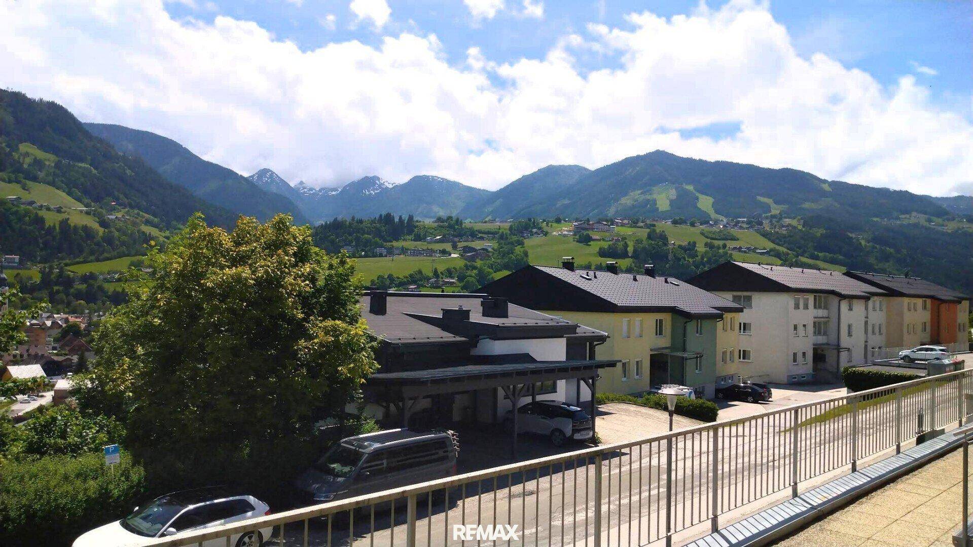 Weitblick auf Wohngebäude und die beeindruckende Bergkulisse in der Ferne.