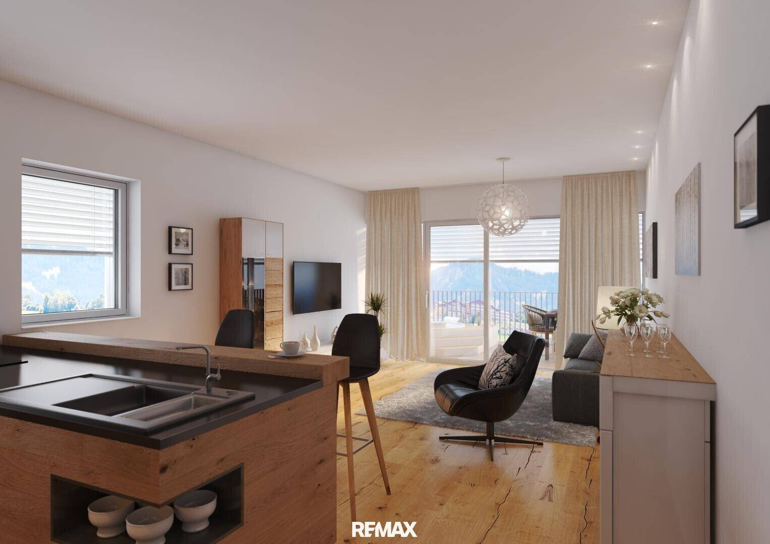 Moderne offene Wohnküche mit Holzboden und Zugang zu einem Balkon mit Bergblick.