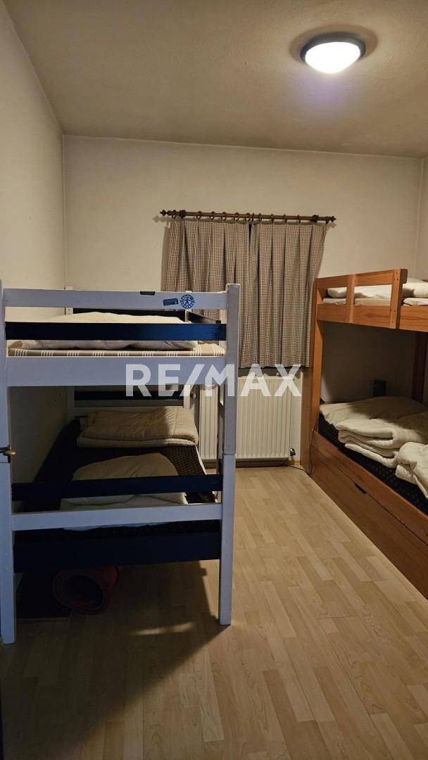 Praktisches Schlafzimmer mit Etagenbetten und Holzboden, ideal für Gäste oder Kinder.