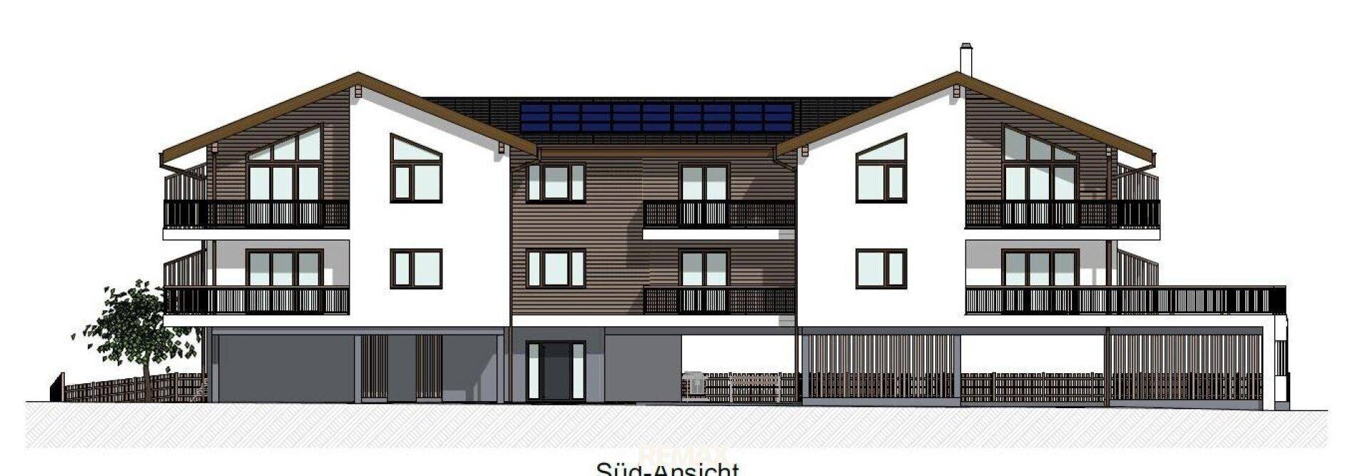 Süd-Ansicht des Gebäudes mit Balkonen, Satteldach und Photovoltaik-System auf dem Dach.