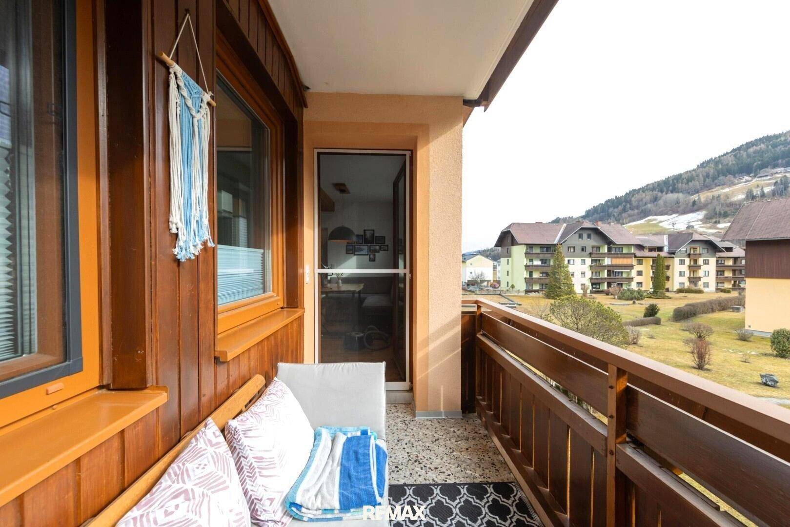 Gemütlicher Balkon mit Sitzgelegenheiten und Blick auf die Berge.