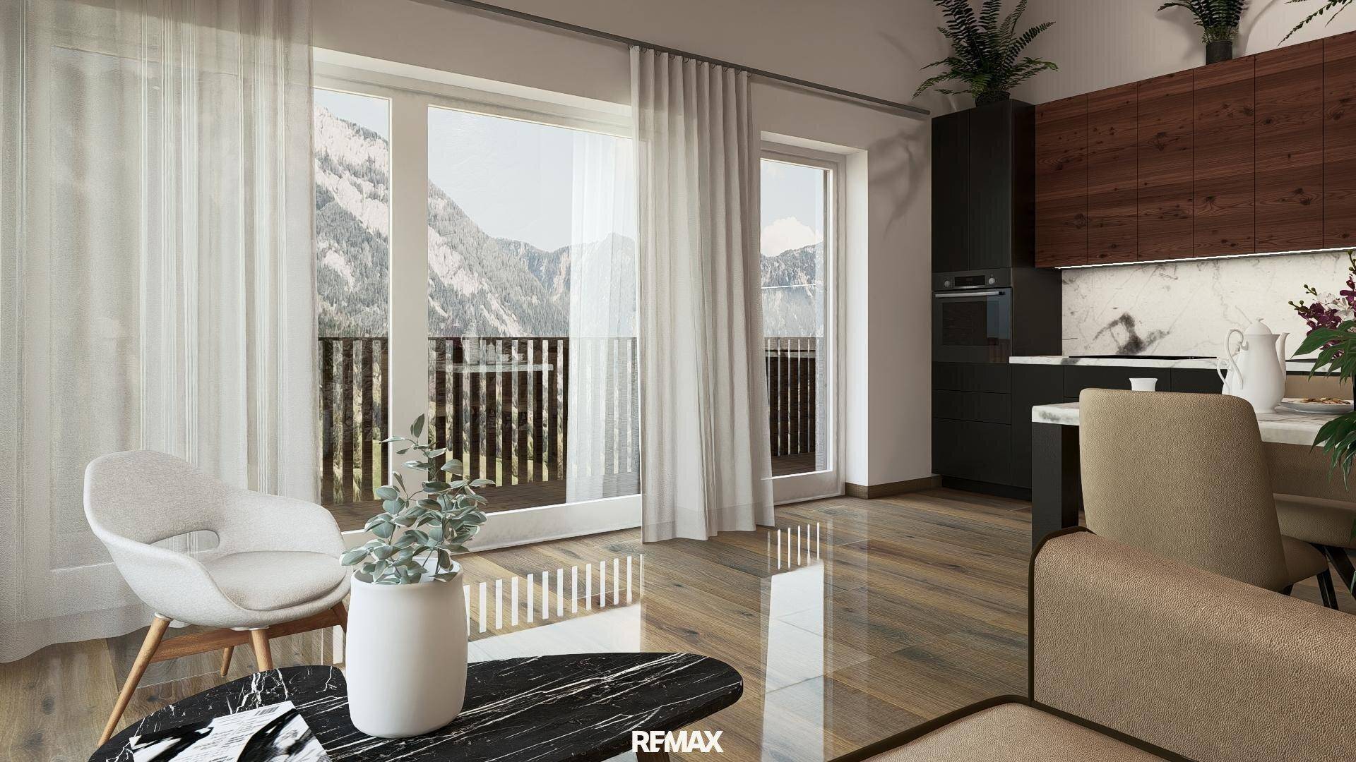 Heller Wohnbereich mit Bergblick, Holzboden und moderner offener Küche im Hintergrund.
