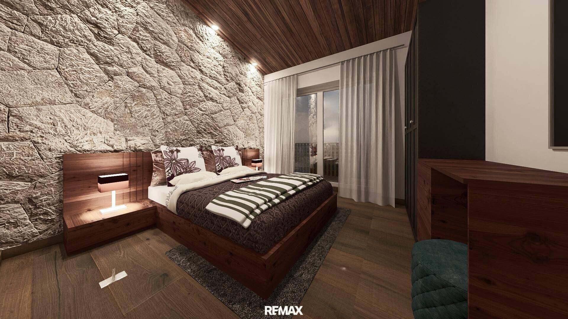 Gemütliches Schlafzimmer mit Holzbett, Steinwand und Zugang zu einem Balkon.