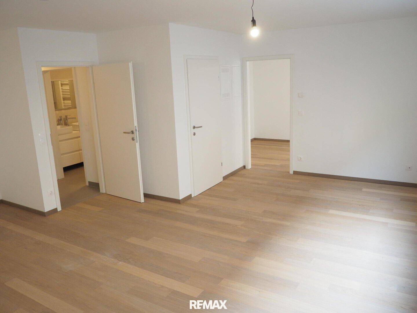 Heller Flur mit Parkettboden, der mehrere Räume der Wohnung miteinander verbindet.