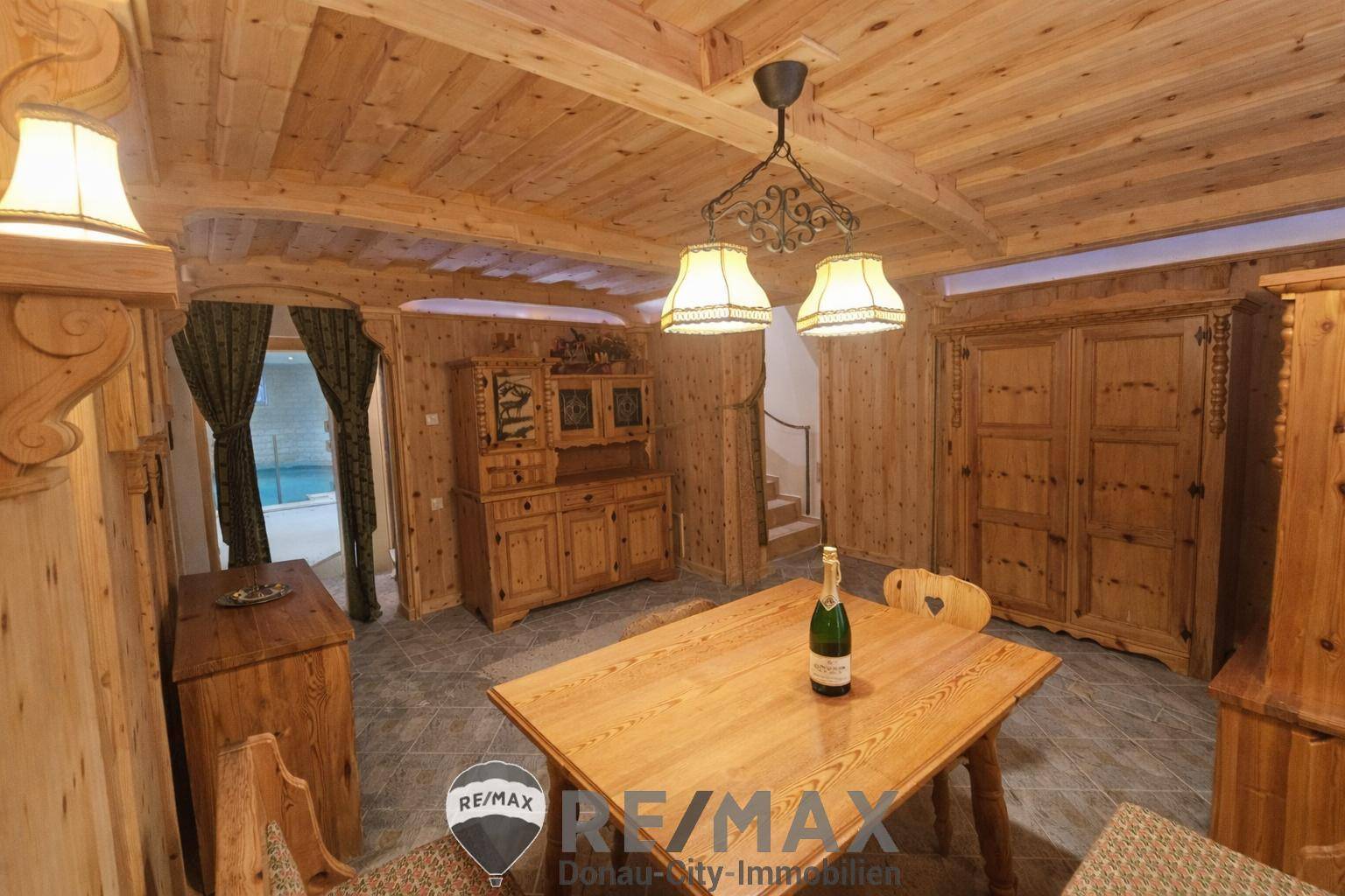 Rustikaler Essbereich mit viel Holzvertäfelung, traditionellen Möbeln und Steinfliesenboden.