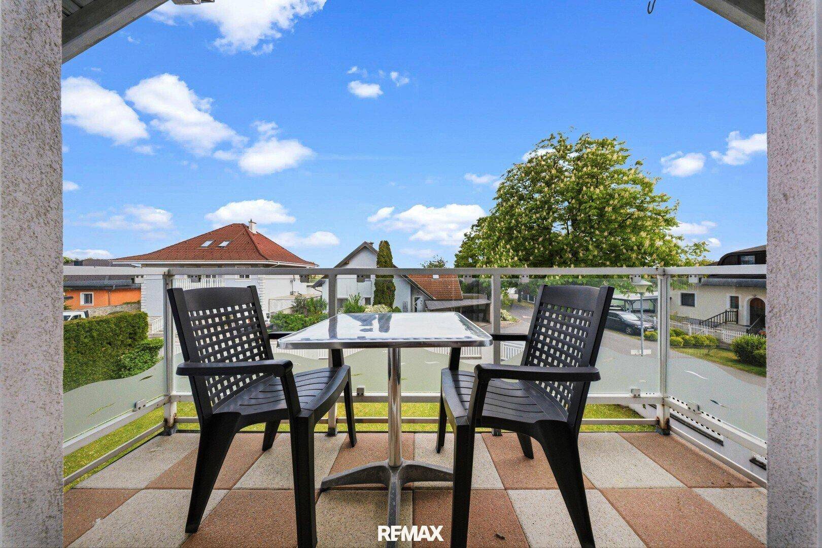 Kleiner Balkon mit Sitzgelegenheiten und Blick auf die Umgebung.