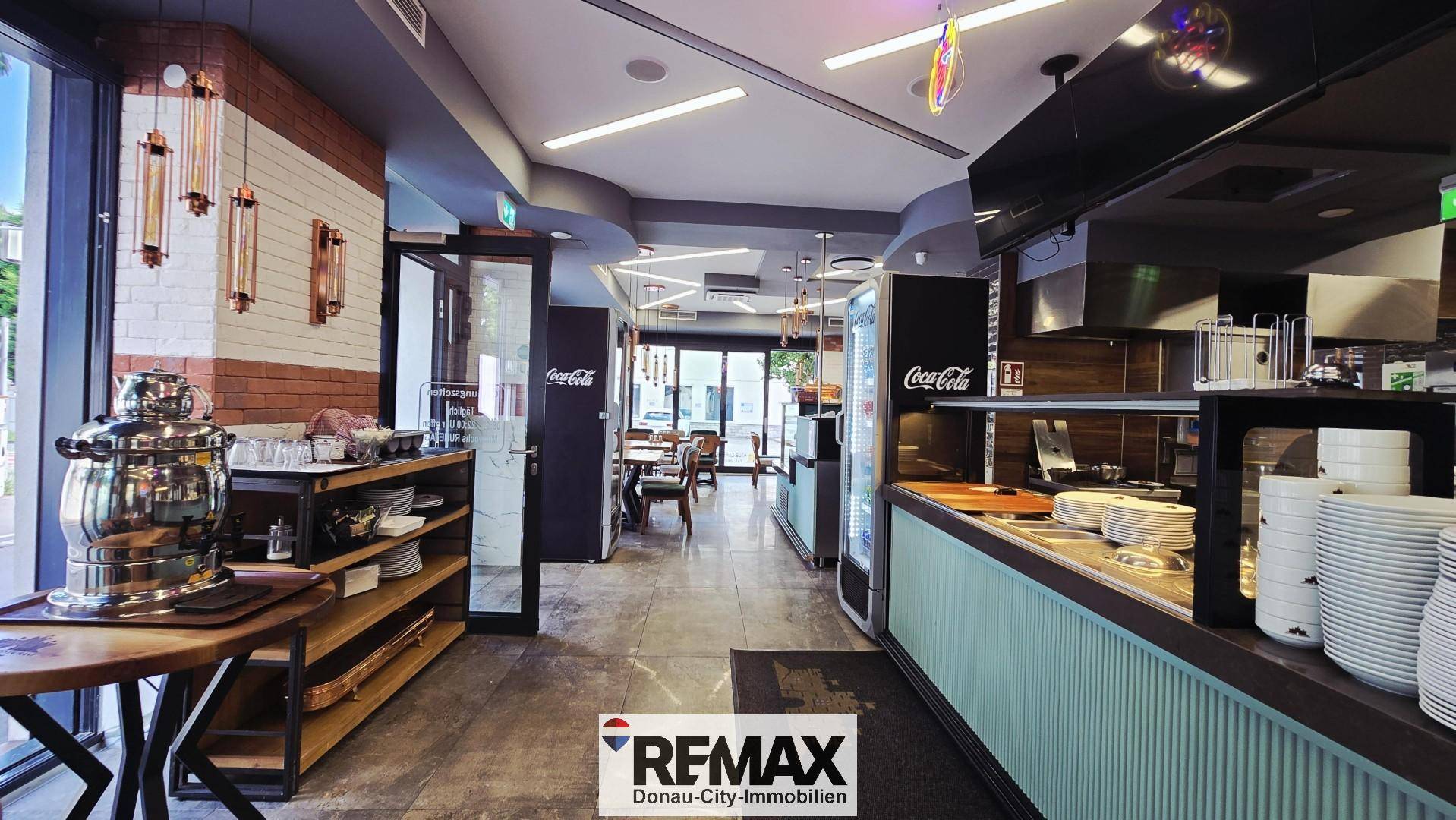 Funktionaler Servicebereich des Restaurants mit Theke, Geschirr und Zugang zur Küche.