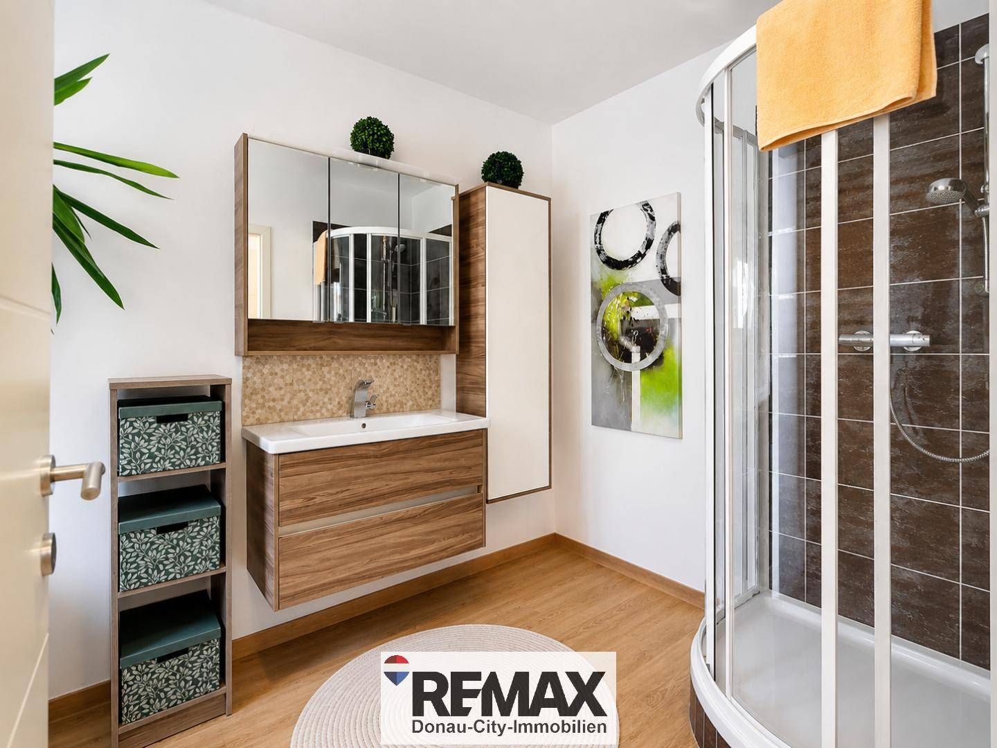 Modernes Badezimmer mit Duschkabine, Waschtisch und Spiegelschrank.