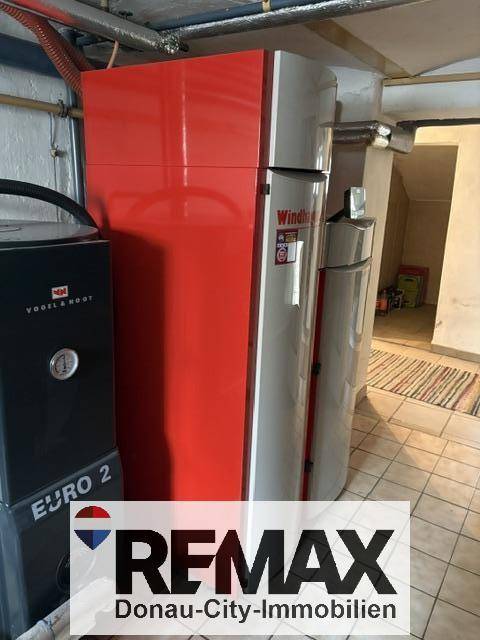 Heizraum im Keller mit modernen Heizungsanlagen und Warmwasserspeicher.