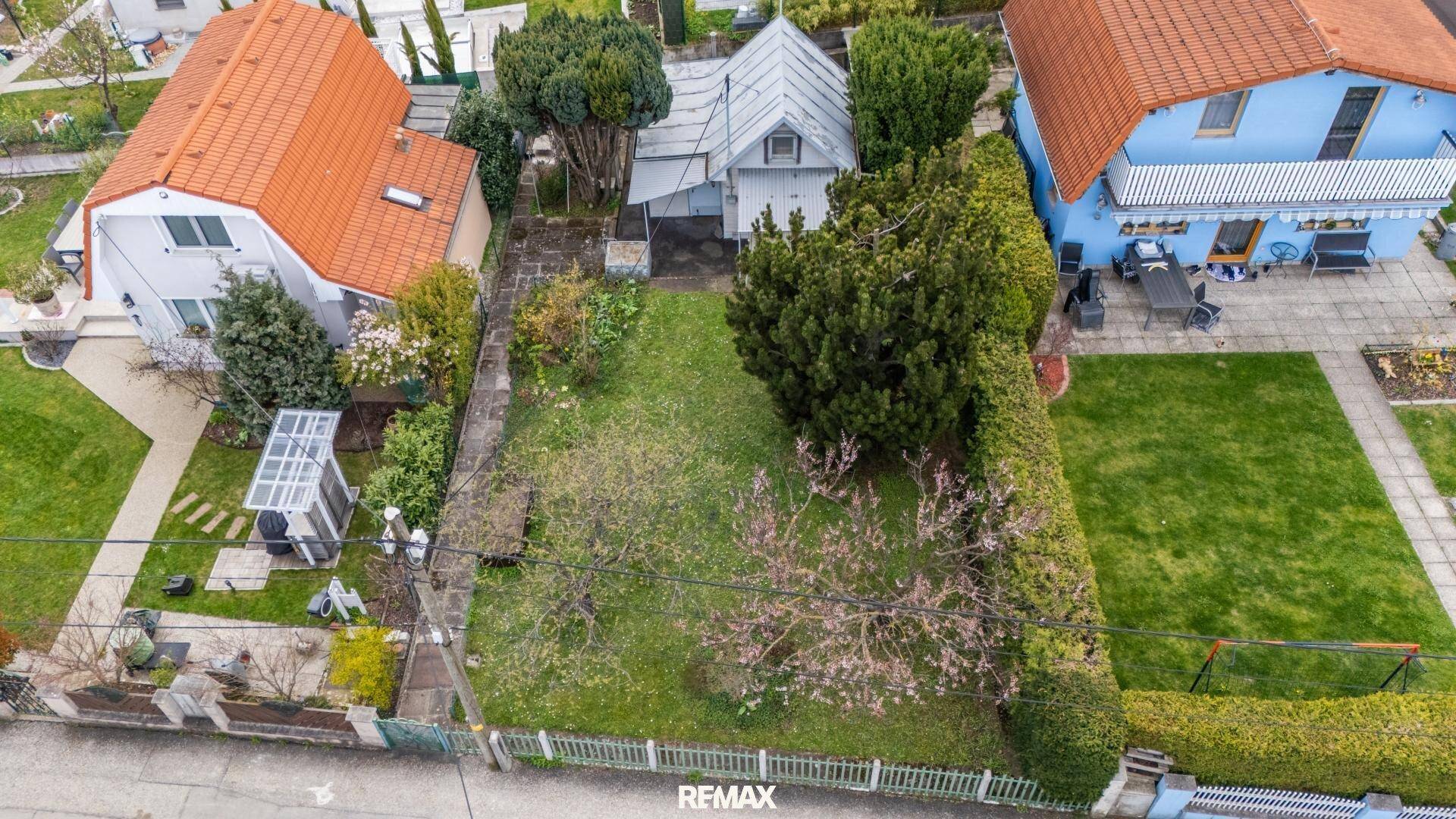 Übersichtliche Luftaufnahme des Grundstücks mit Garten, Haus und angrenzenden Gebäuden.