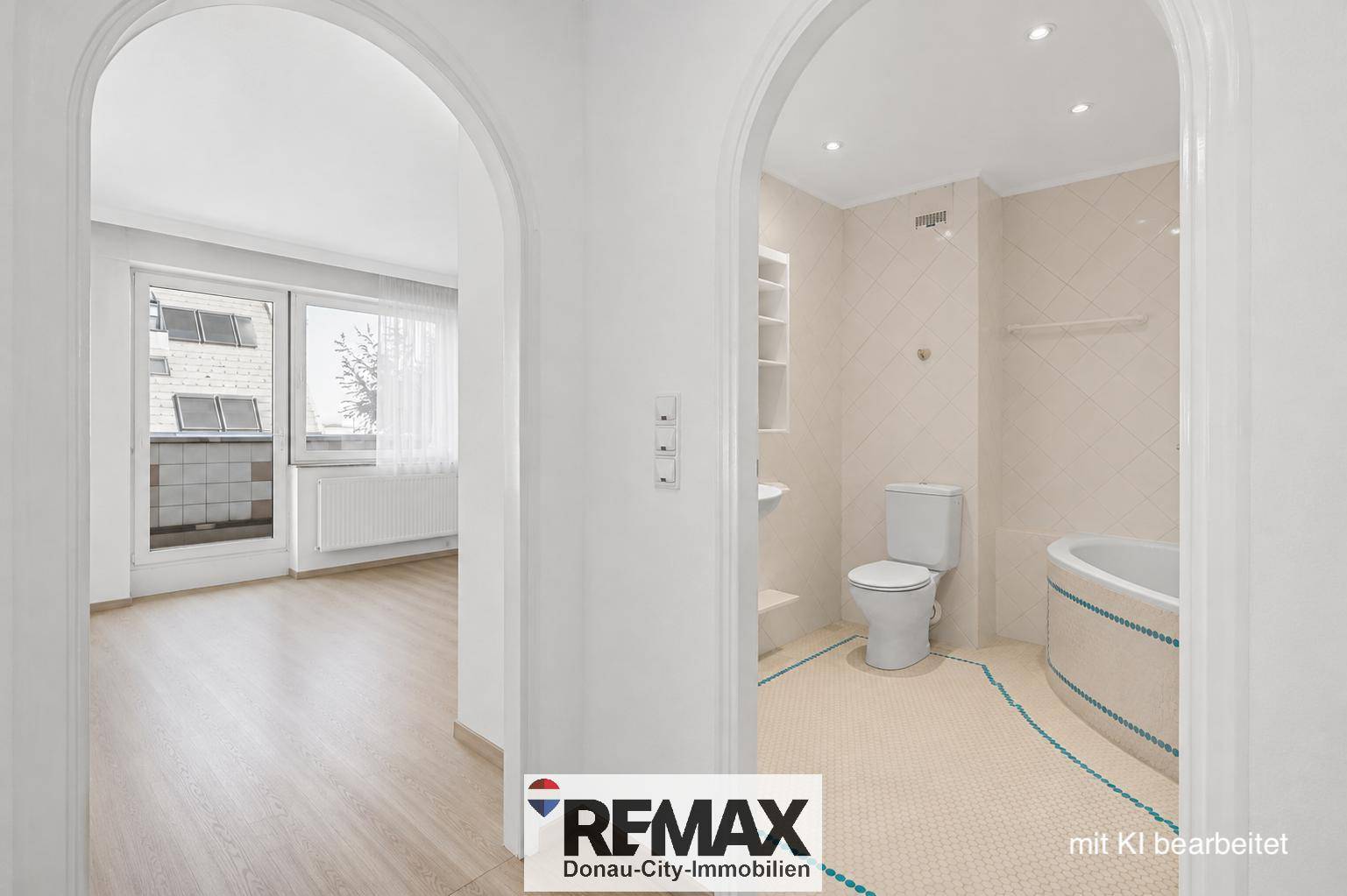 Badezimmer mit Toilette und Badewanne, verbunden durch einen Torbogen zu einem hellen Raum.