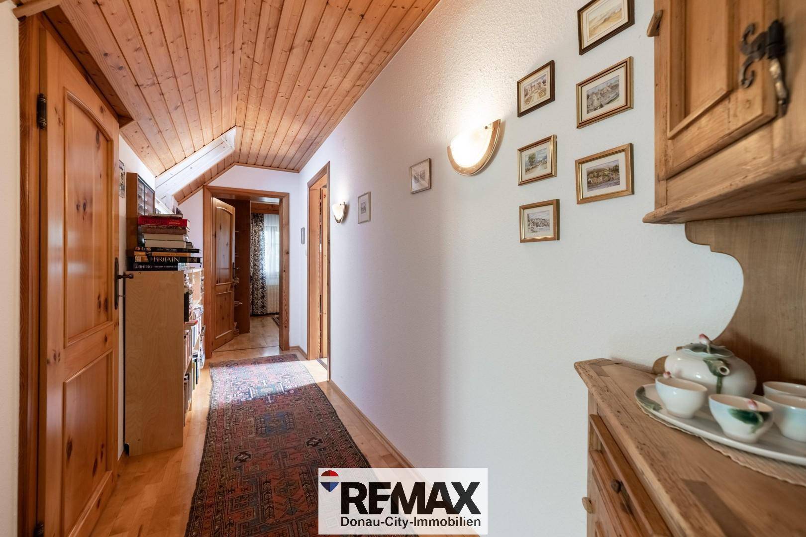 Gemütlicher Flur mit Holzvertäfelung an der Decke und traditionellen Holztüren.