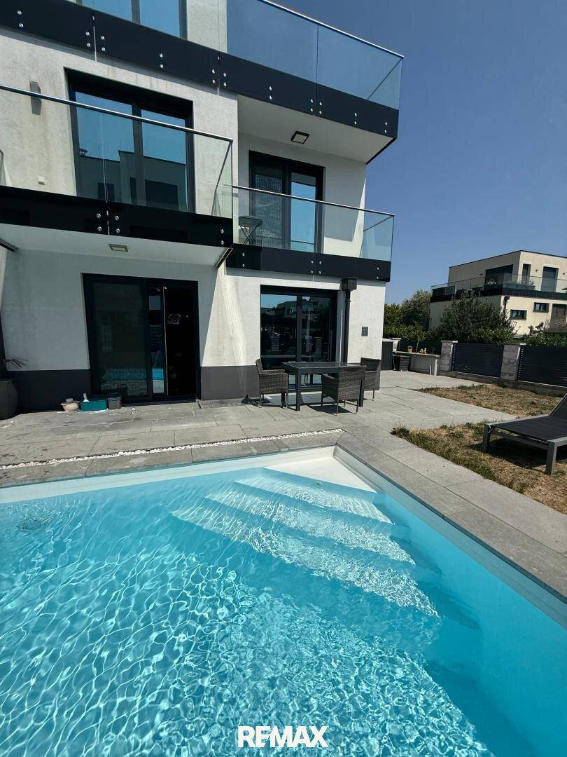Außenbereich mit erfrischendem Pool und moderner Architektur des Gebäudes.