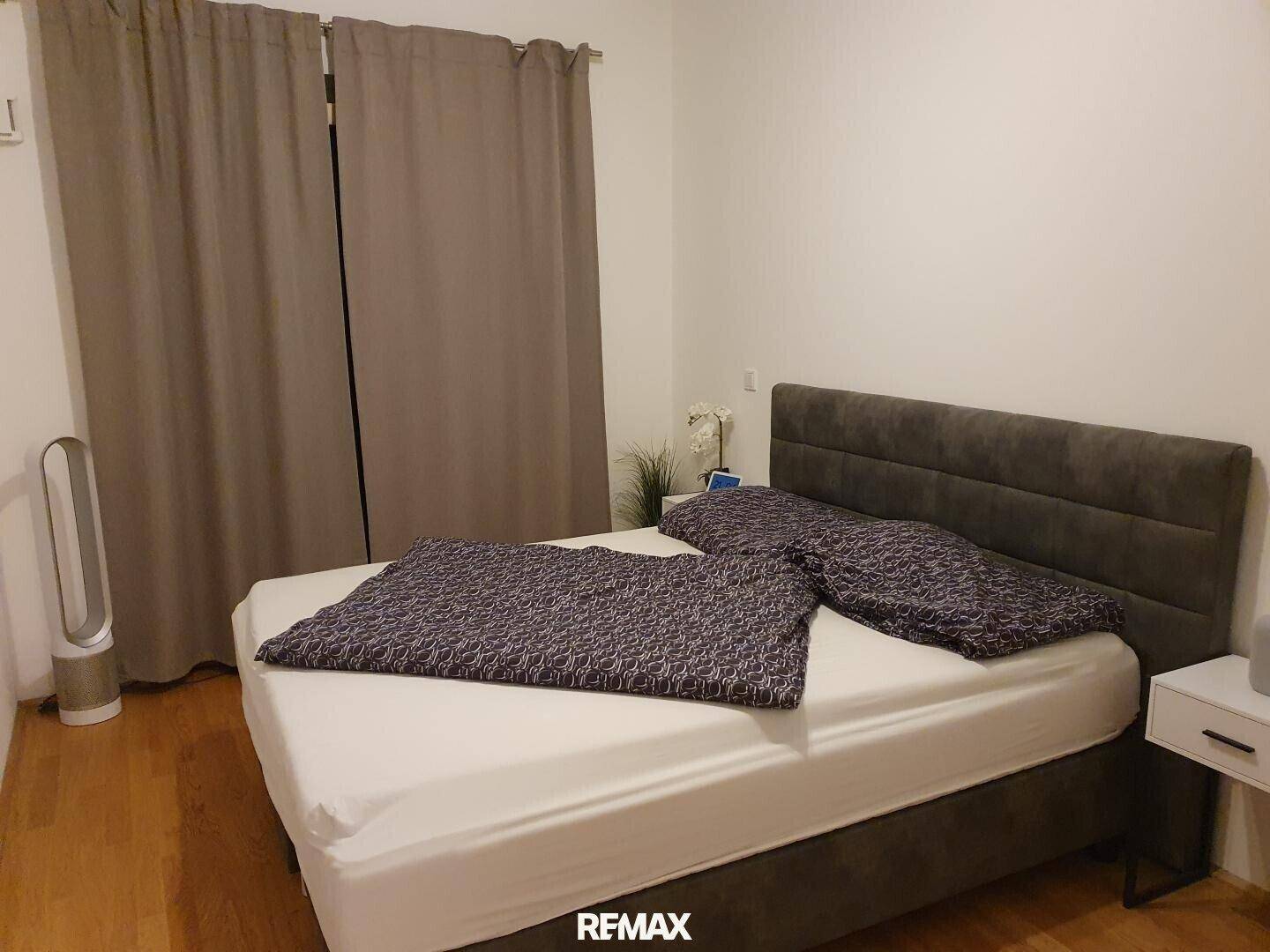 Ruhiges Schlafzimmer mit bequemem Doppelbett, Nachttischen und Holzboden.