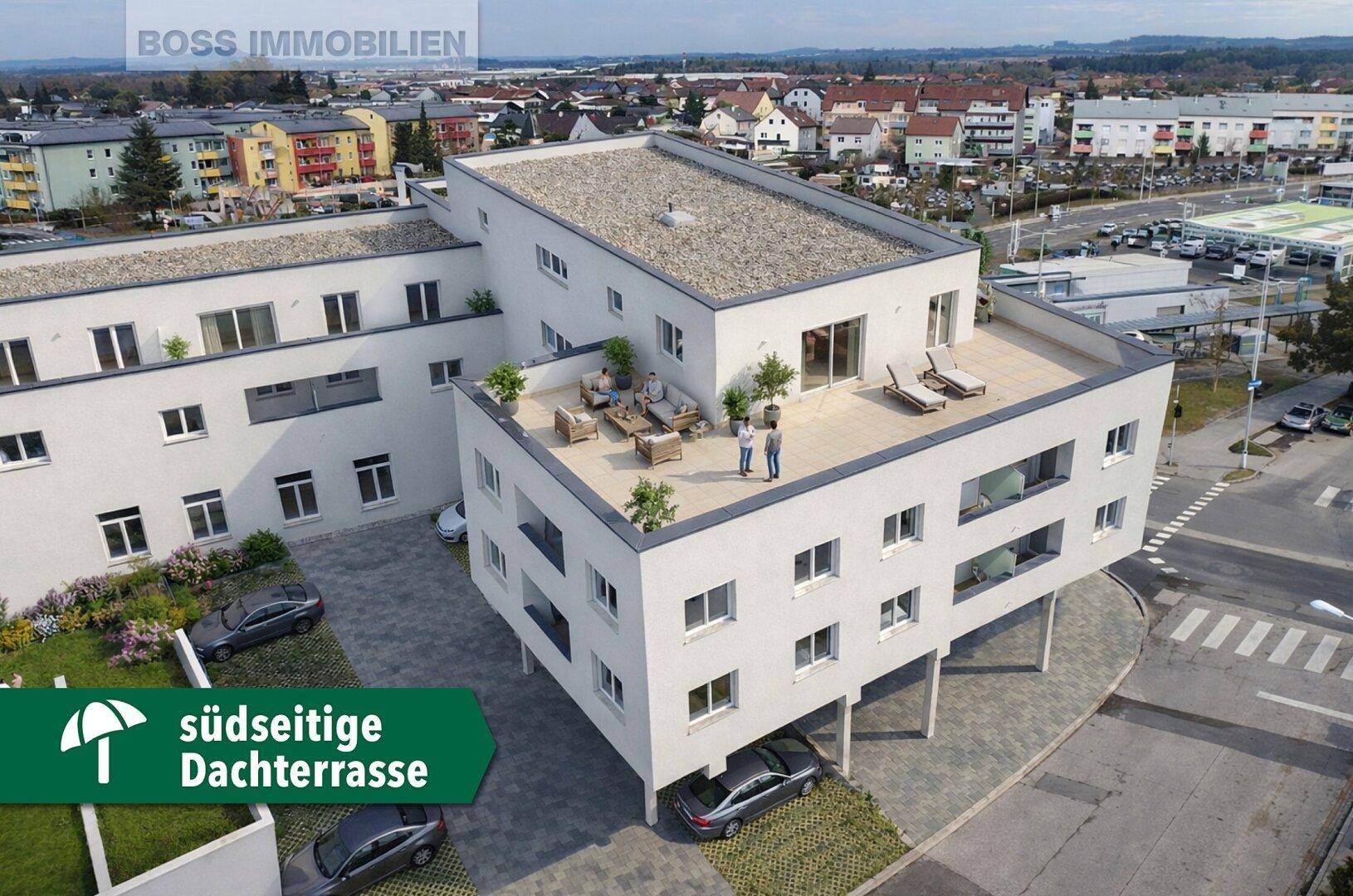 Moderne Wohnanlage mit großer südseitiger Dachterrasse und Sitzgelegenheiten im Freien.