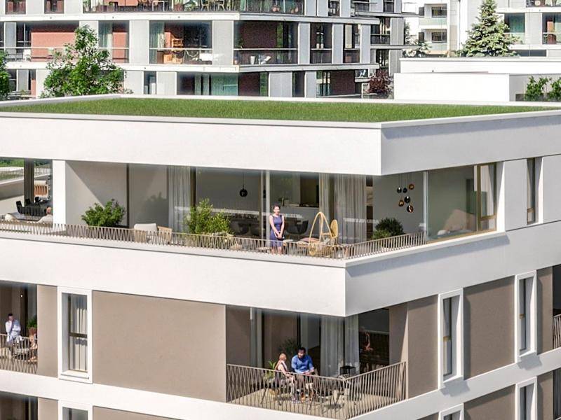 Moderne Wohnanlage mit begrüntem Flachdach und großzügigen Balkonen und Terrassen.