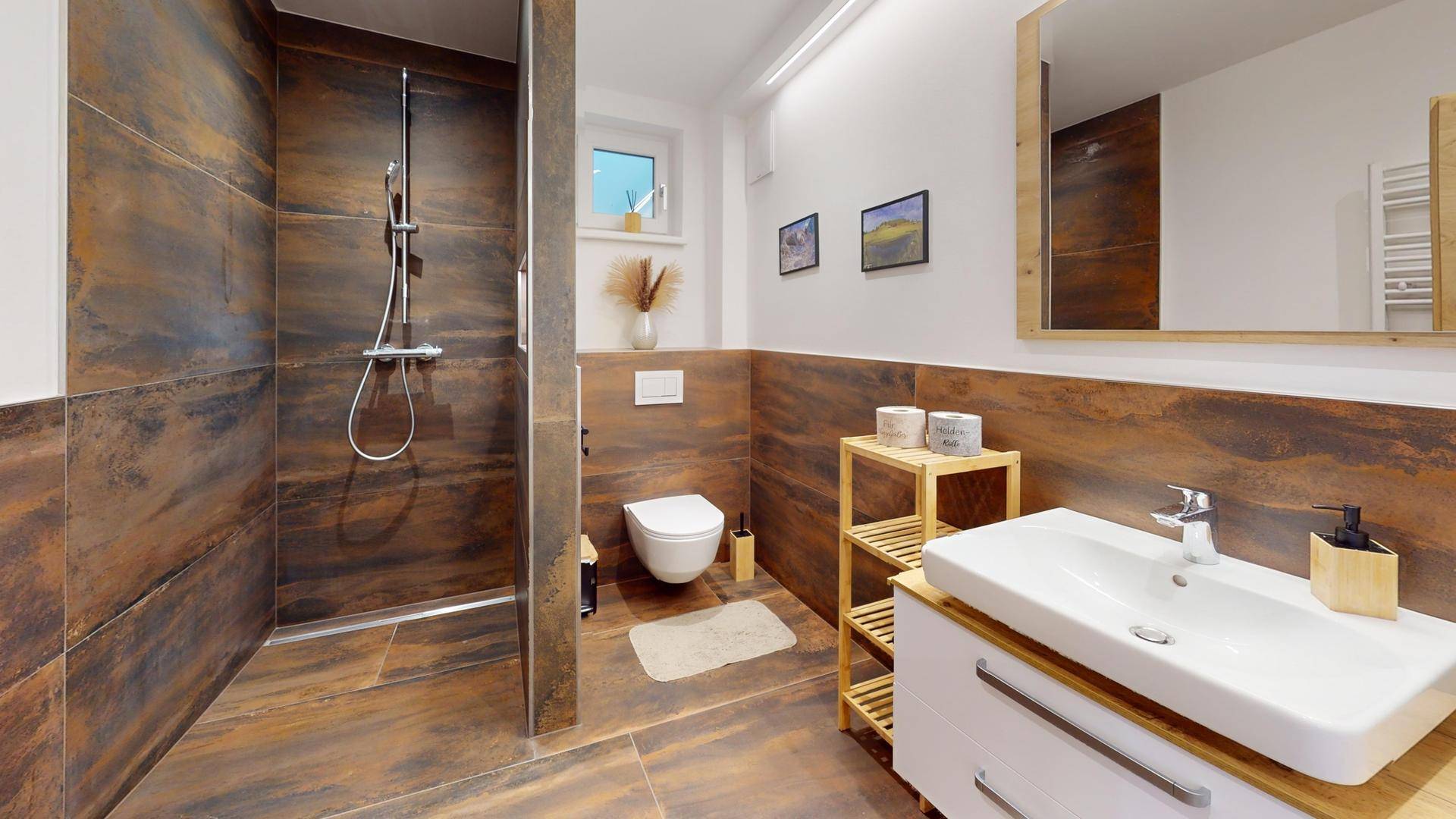 Modernes Badezimmer mit Einzelwaschbecken, WC und ebenerdiger Dusche.