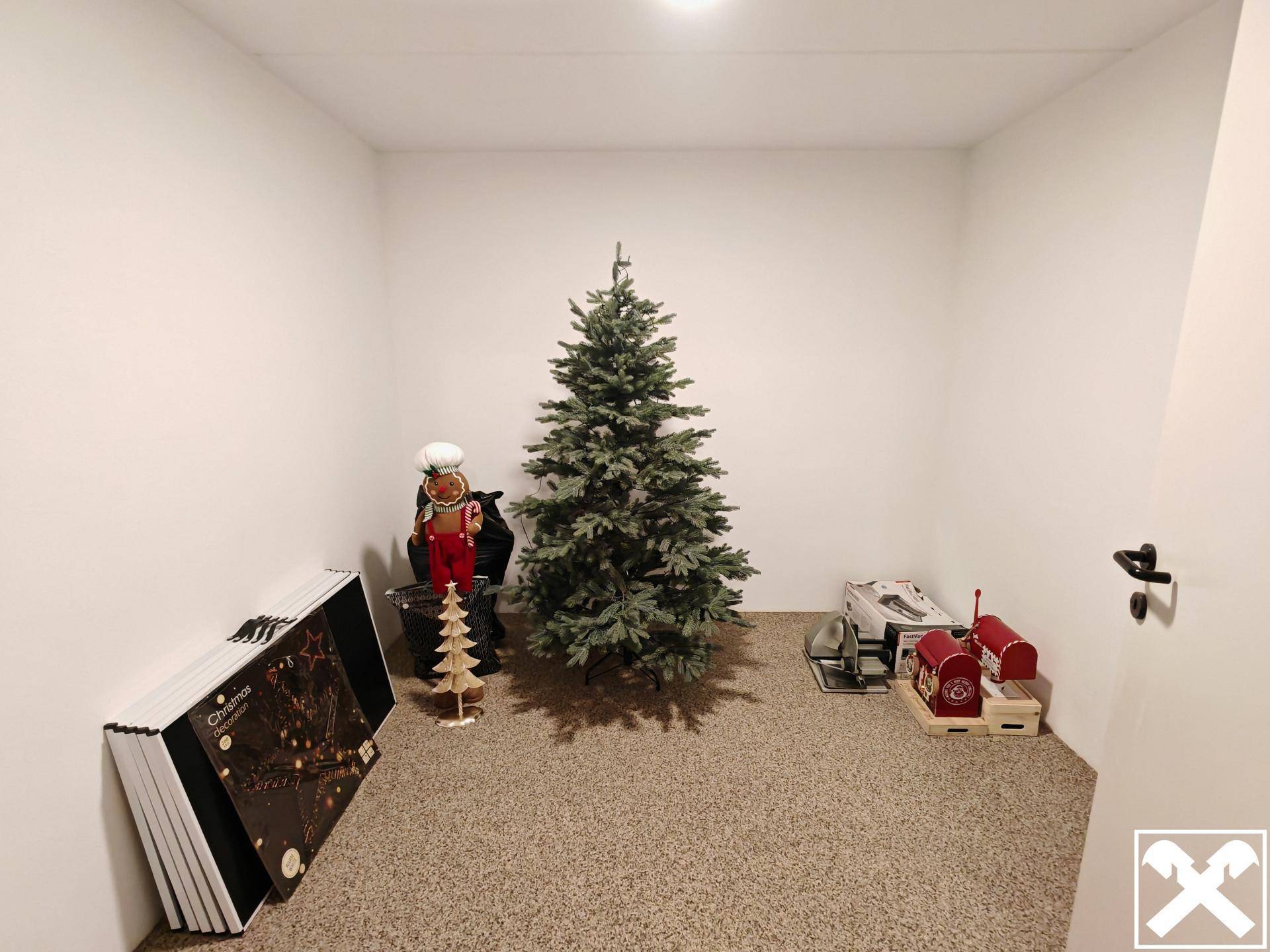 Lagerraum mit Weihnachtsbaum und verschiedenen saisonalen Dekorationsartikeln.