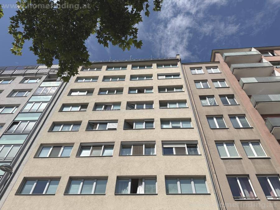 Ansicht der modernen Gebäudefassade mit zahlreichen Fenstern und Balkonen.