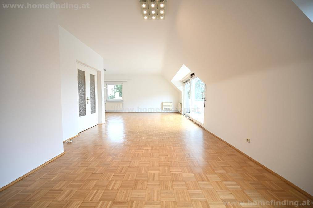 Geräumiger Wohnbereich mit Parkettboden, Dachschrägen und viel Tageslicht.