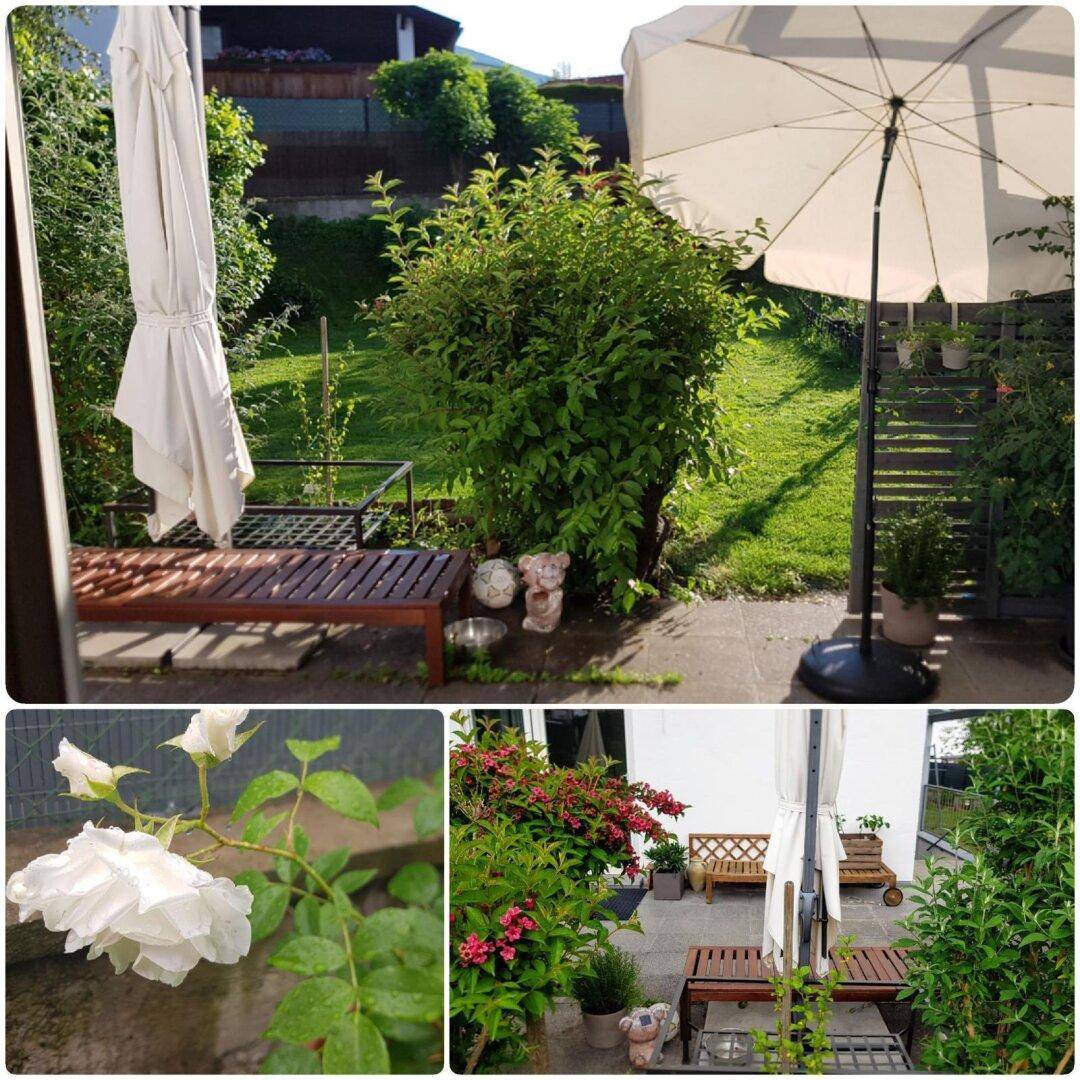 Gemütlicher Außenbereich mit Sonnenschirm, Sitzbank und blühenden Rosen im gepflegten Garten.