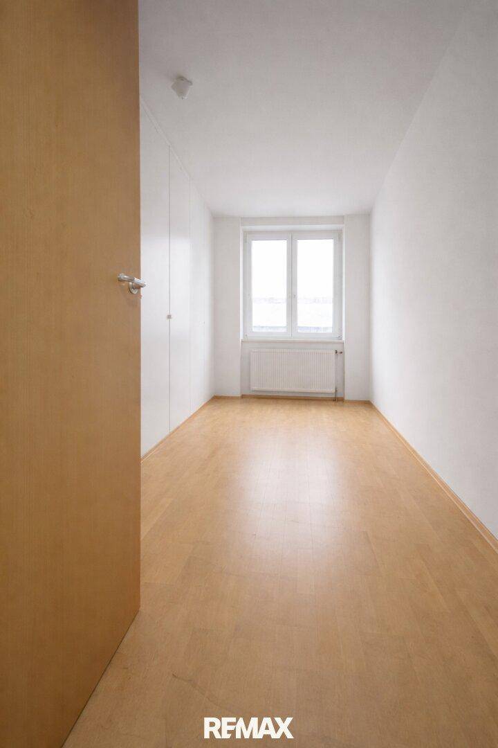 Ruhiges Zimmer mit Laminatboden und Fenster, geeignet als Schlaf- oder Arbeitszimmer.