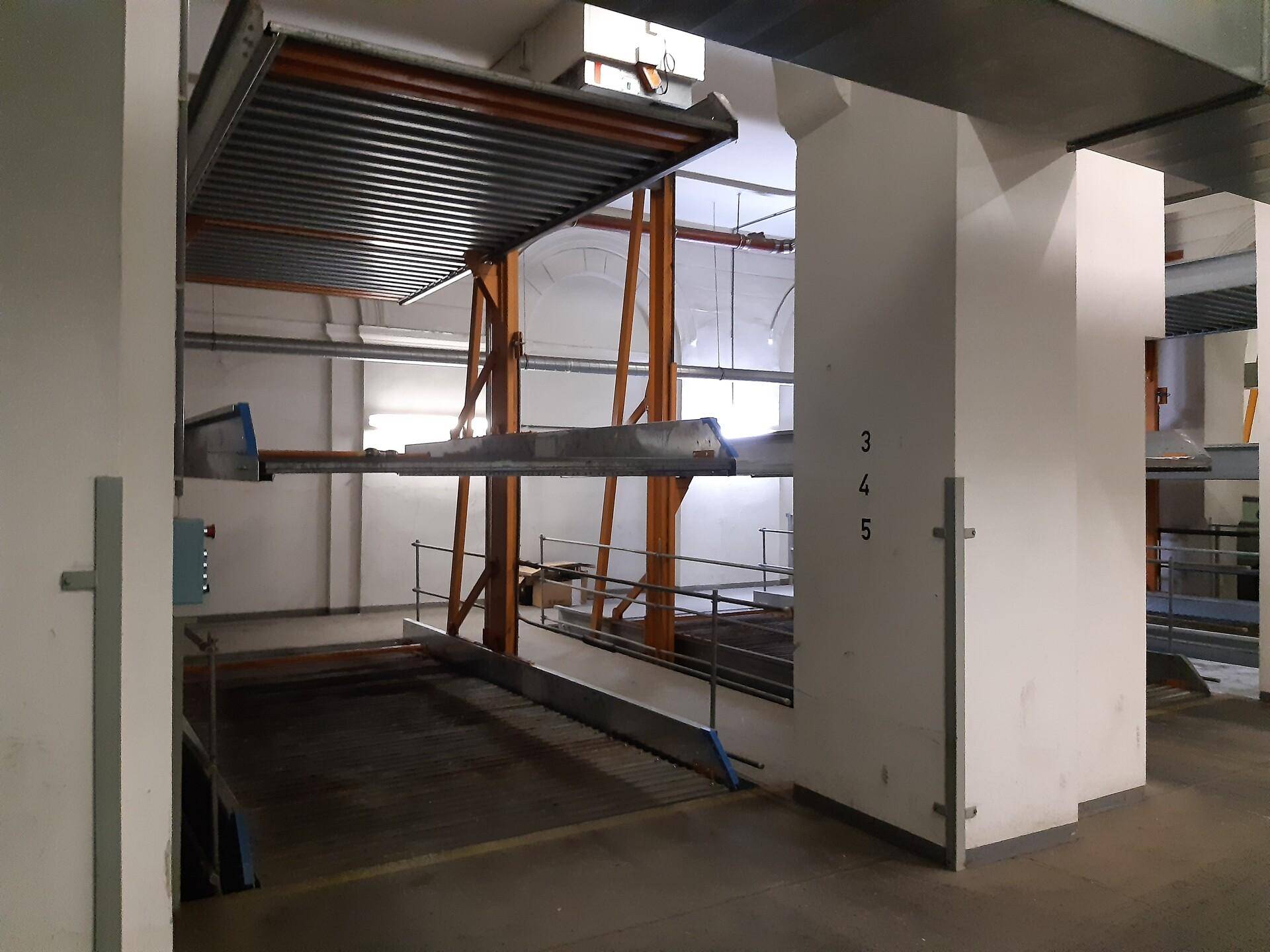 Blick auf das automatische Parksystem in der Tiefgarage mit hohen Decken und solider Bauweise.