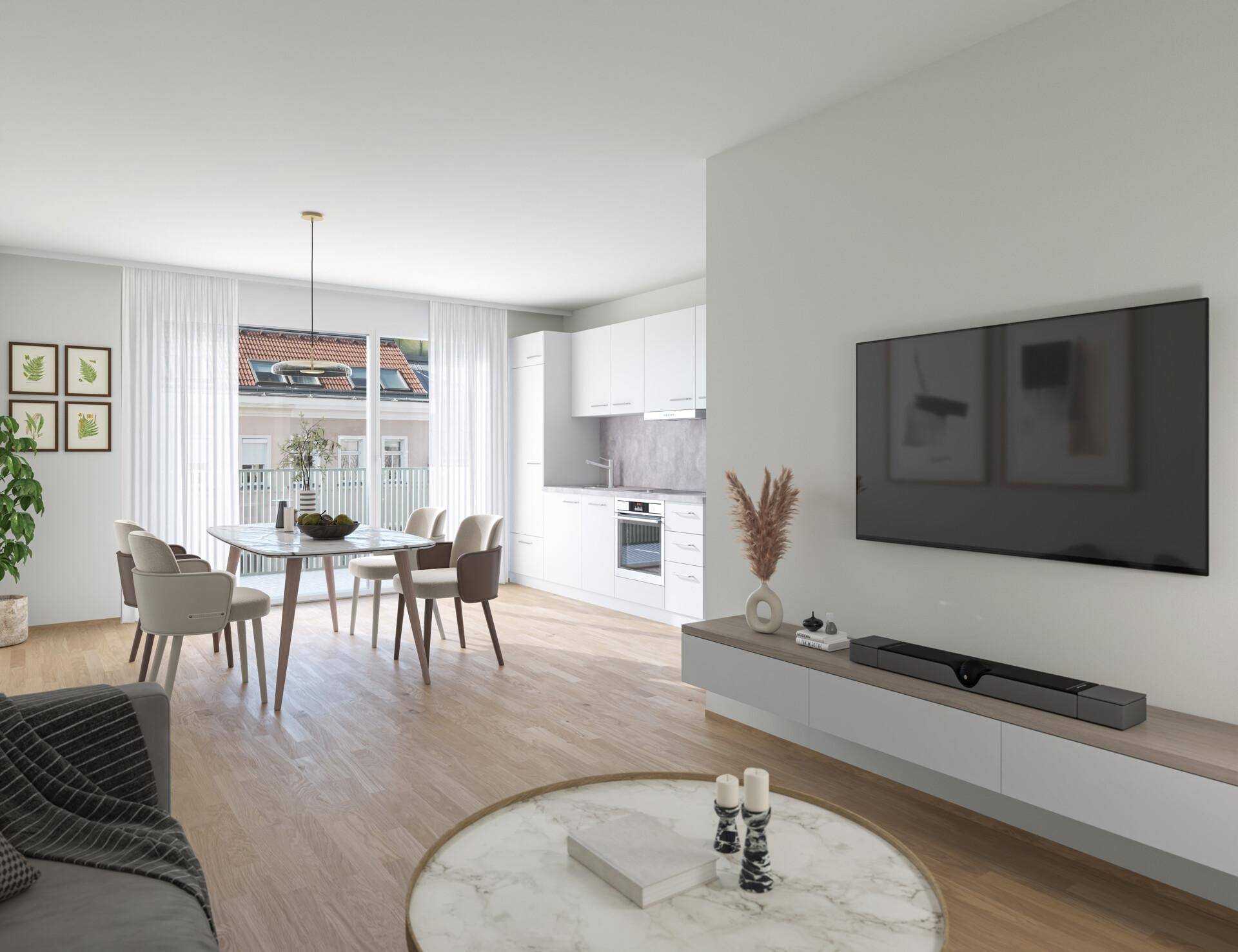 Heller Wohn-Essbereich mit integrierter weißer Küche und Holzboden, ideal für modernes Wohnen.