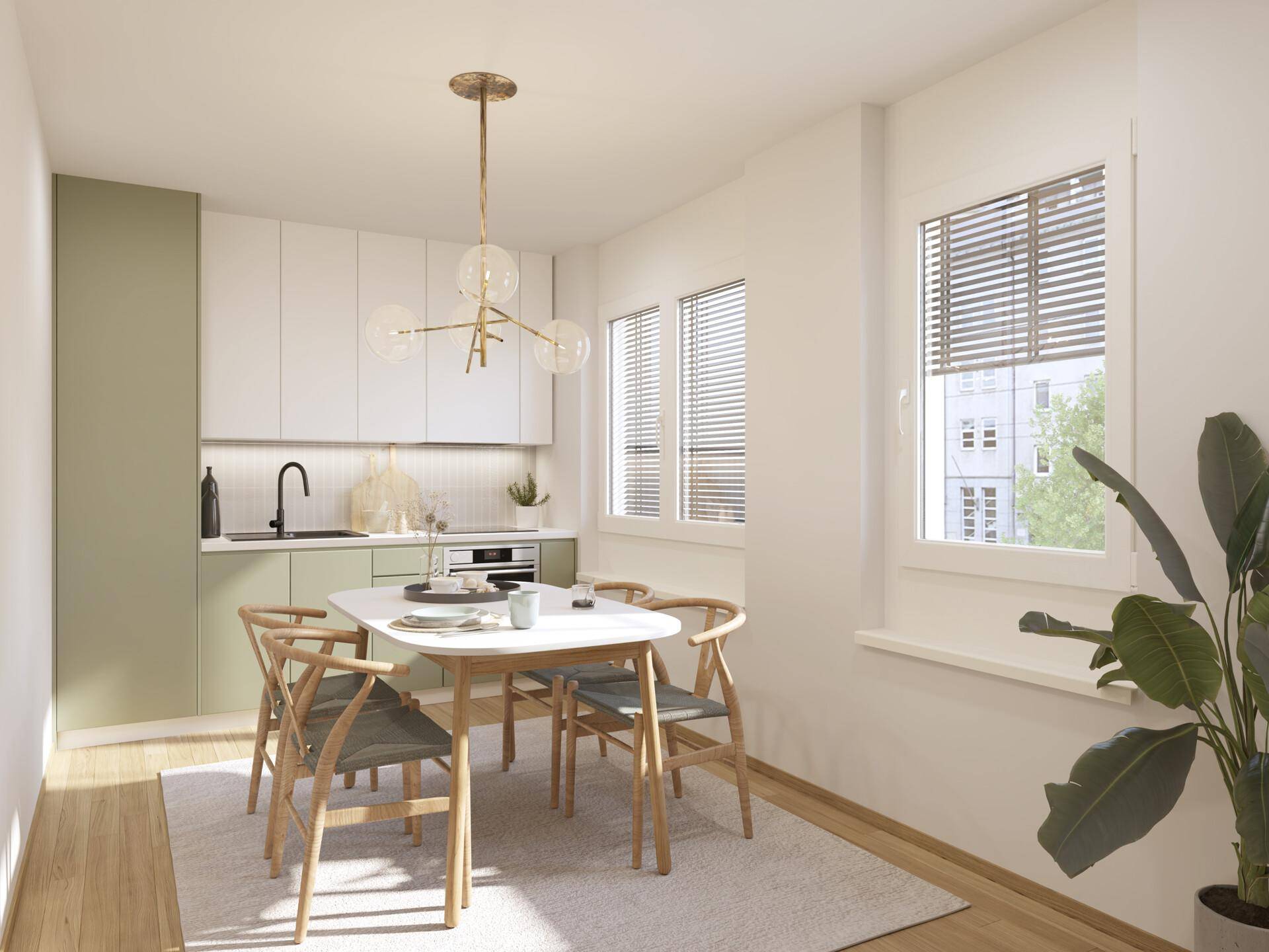 Helle Wohnküche mit moderner Einrichtung, grünen Akzenten und Esstisch am Fenster.