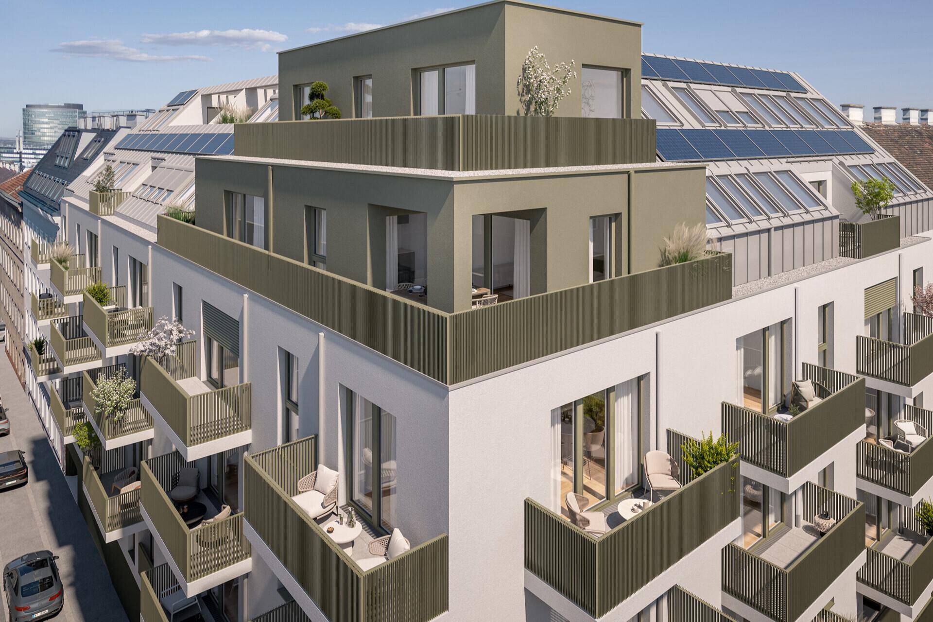 Ansicht des modernen Wohngebäudes von oben mit Dachterrassen und Balkonen in städtischer Umgebung.