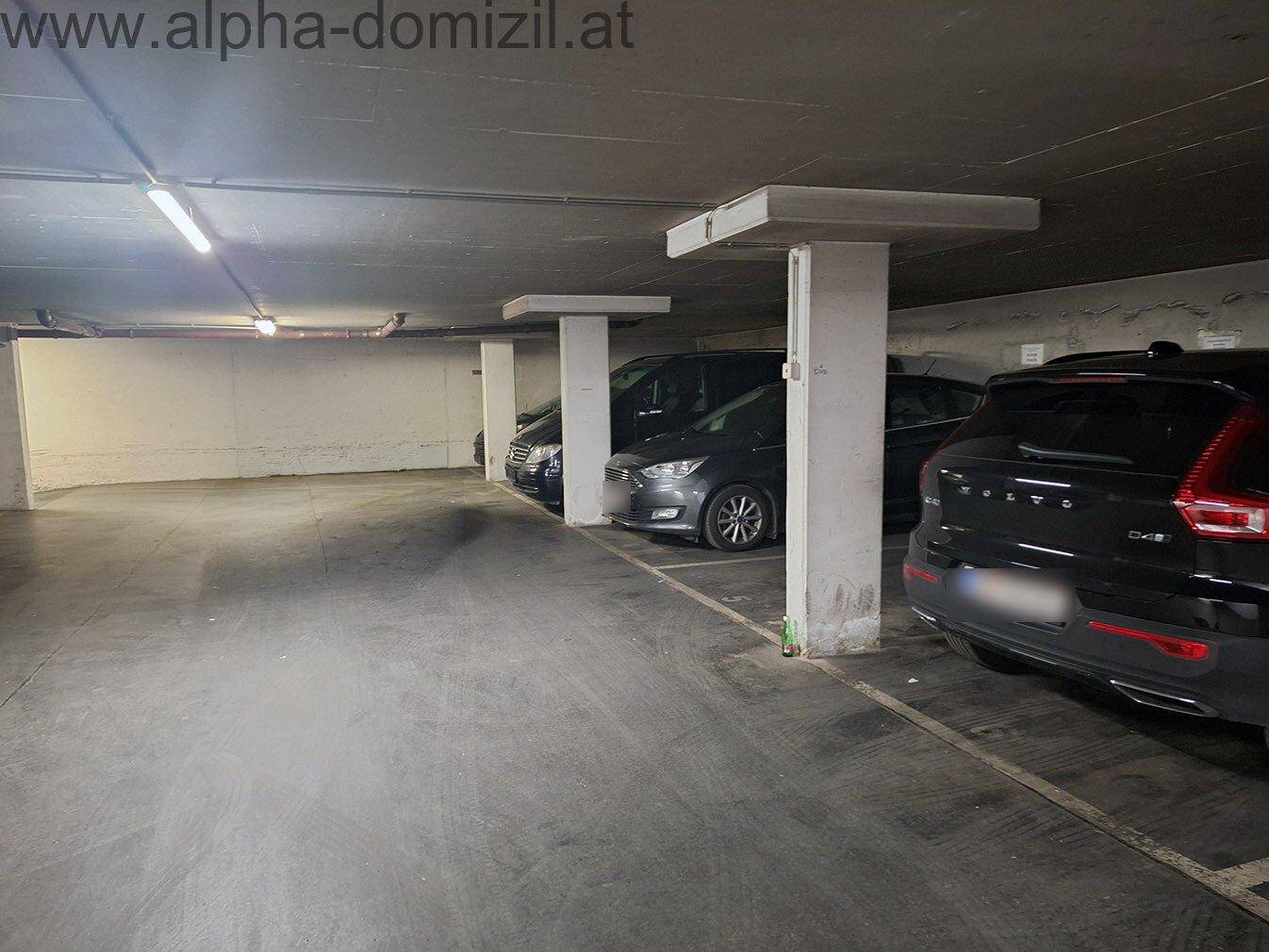 Geräumige Tiefgarage mit mehreren Stellplätzen und Betonpfeilern.