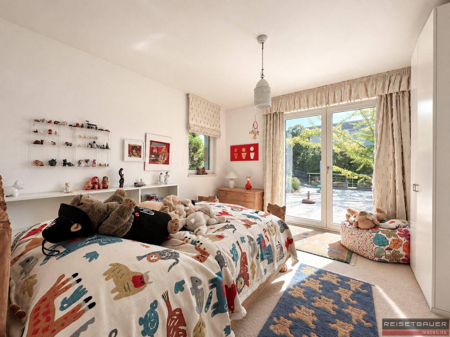 Kinderzimmer mit zwei Betten, Teppichboden und Zugang zu einem Außenbereich.