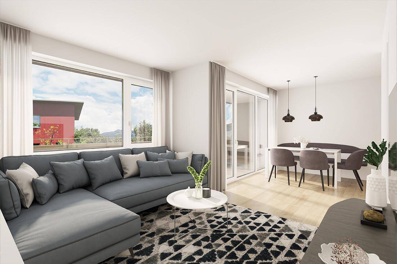 Heller, offener Wohn- und Essbereich mit modernem Sofa, Esstisch und großen Fenstern mit Ausblick.