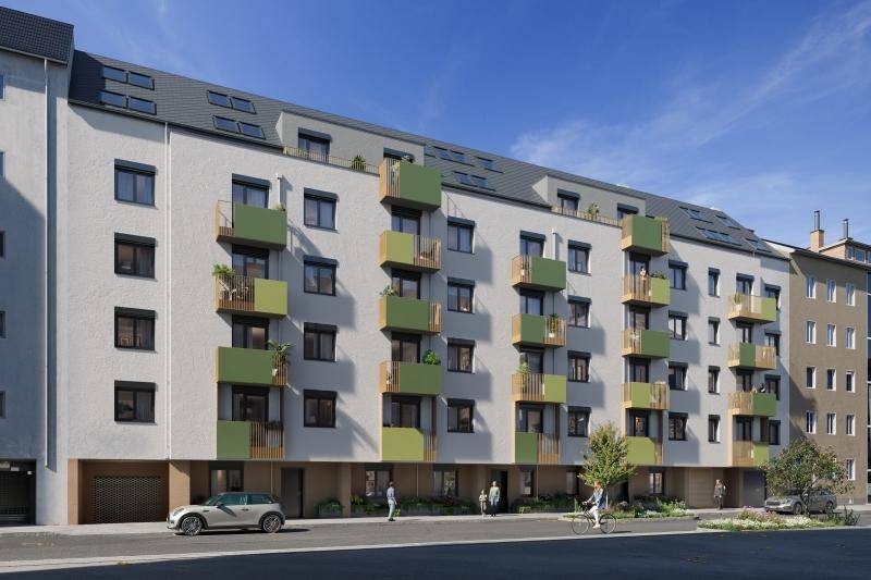 Moderne Wohnfassade mit auffälligen grünen Balkonen und großen Fenstern an einer Stadtstraße.