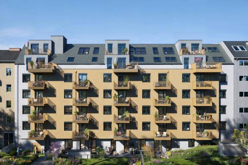 Moderne Wohnanlage mit zahlreichen Balkonen und begrünten Außenbereichen in einer städtischen Umgebung.