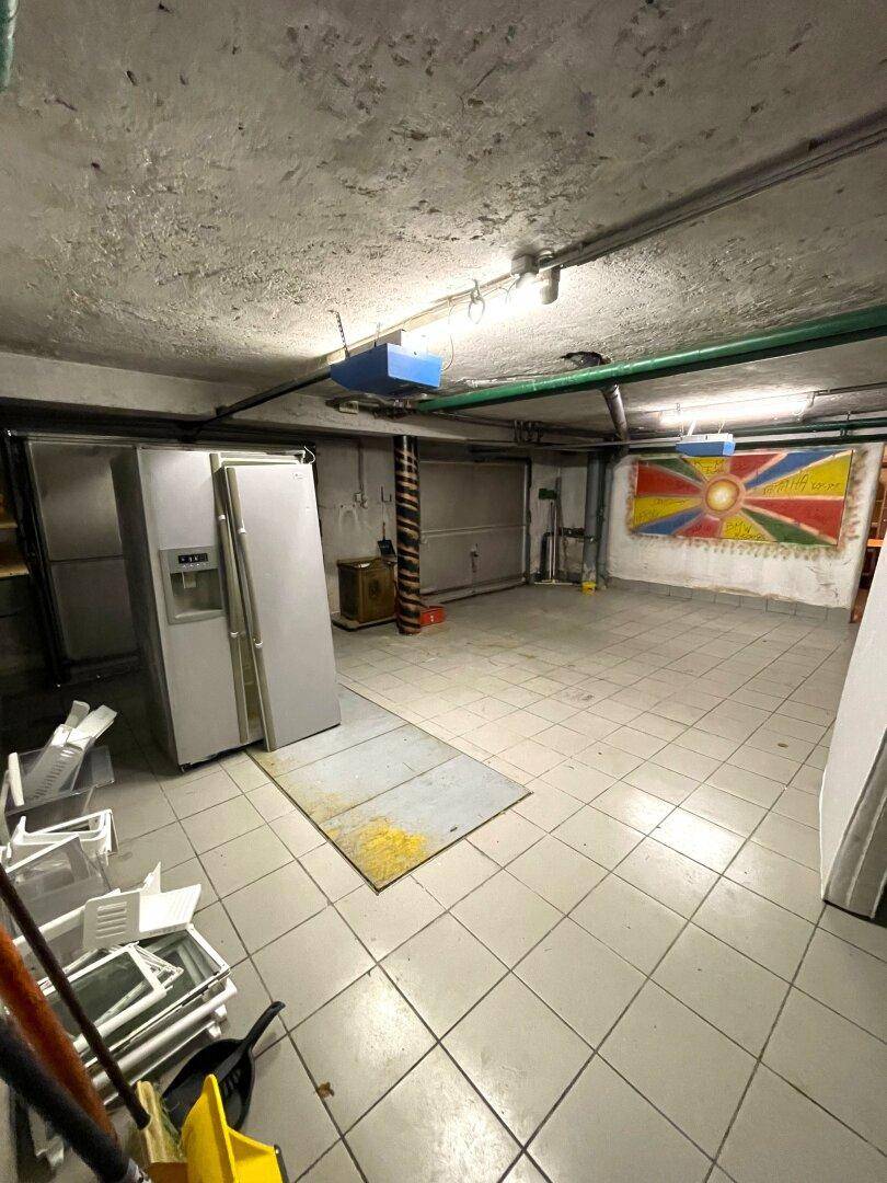 Geräumige Garage mit Fliesenboden und Lagerfläche.