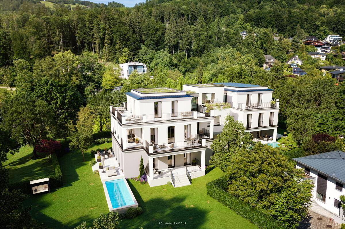 Luftaufnahme der modernen Wohnanlage mit Terrassen, Pool und umgebender Natur.